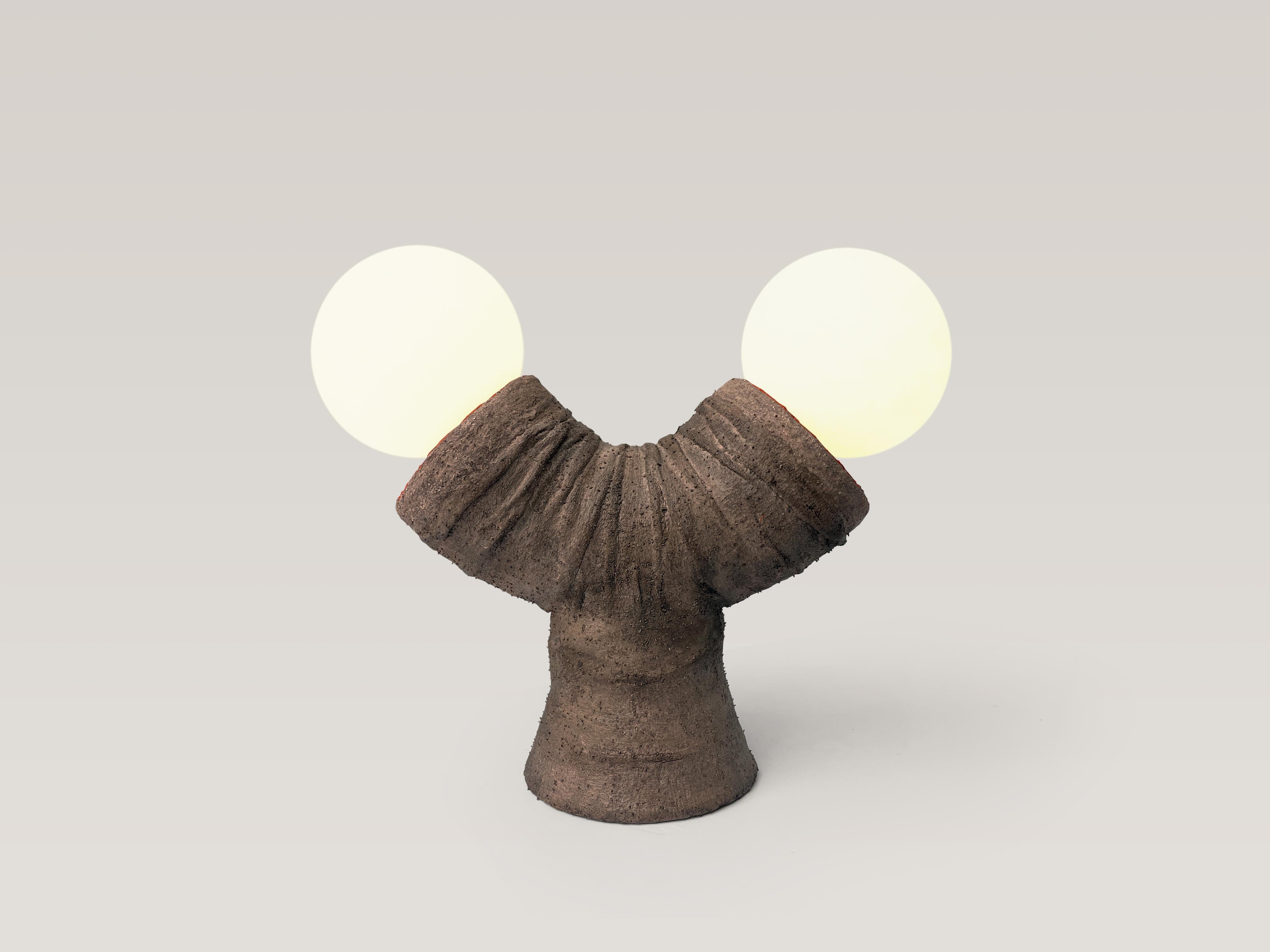 Primitive table lamp. Unique piece.

Material: clay, fabric, reclaimed plastic, PVA, sand, acrylic paint, pigment, polyurethane, electrical components, LED dimmable globes.