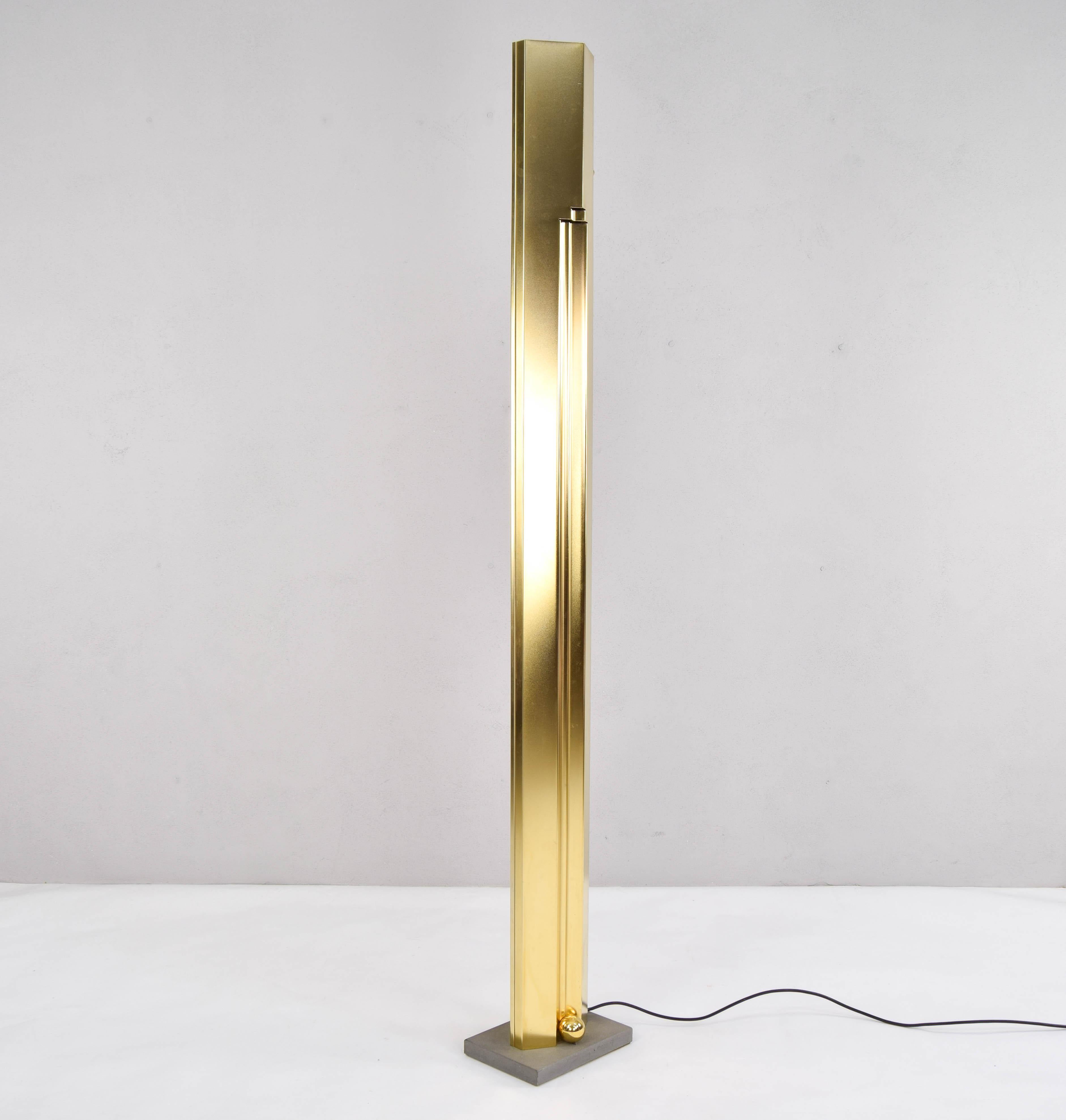 Sculptural large brass floor lamp by Kazuhide Takahama for the Italian firm Sirrah. Body of geometric shapes with detail of two balls in its sandstone base. Adjustable light intensity. Piece in its original state, the brass has some slight marks