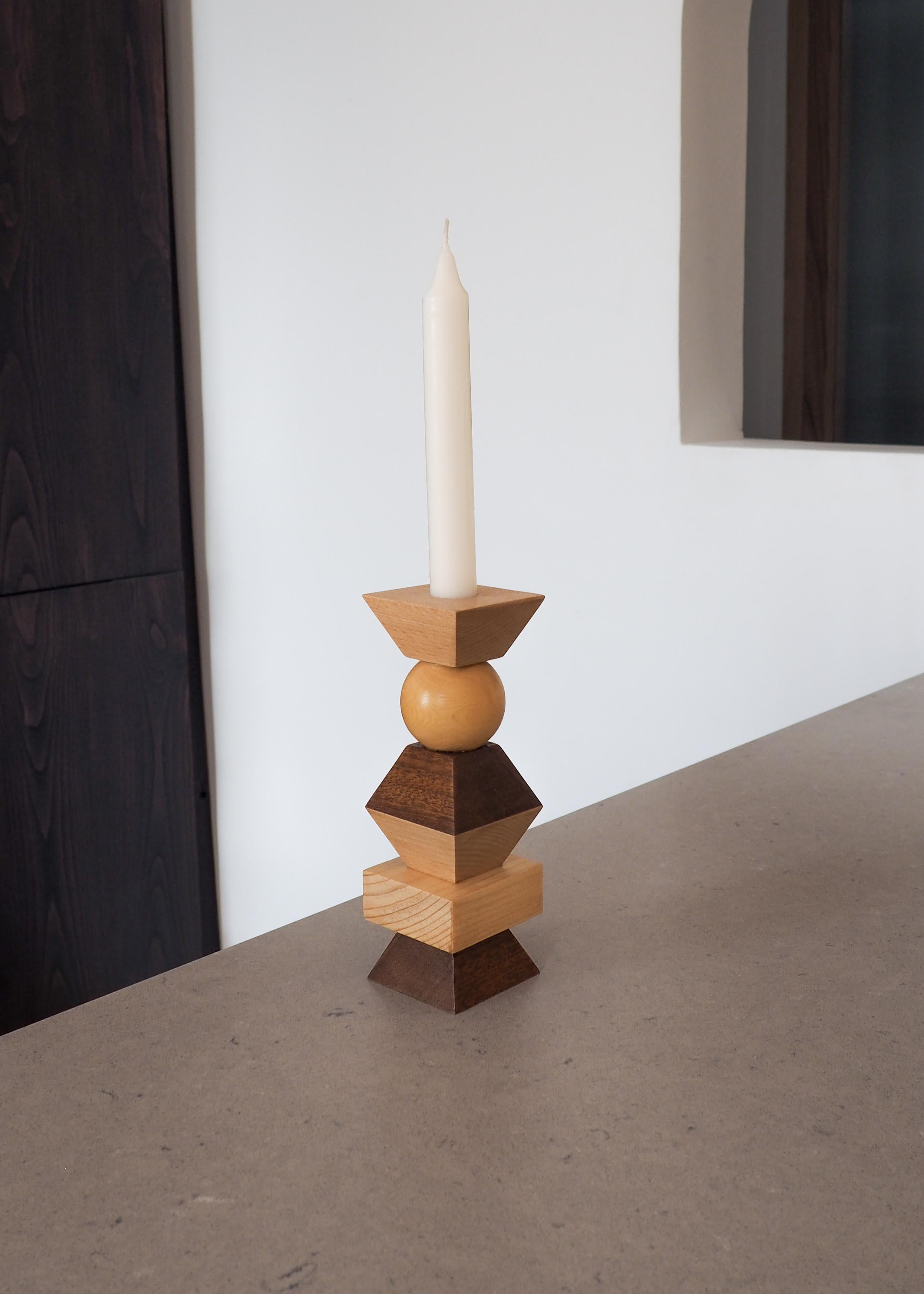 This Totem candlestick is made up of different local essences: Boxwood, Beech, Melia and Pine. It was produced in the Languedoc, in France. Its geometric shapes make it a sculptural object. A satin varnish has been applied to protect the wood. There