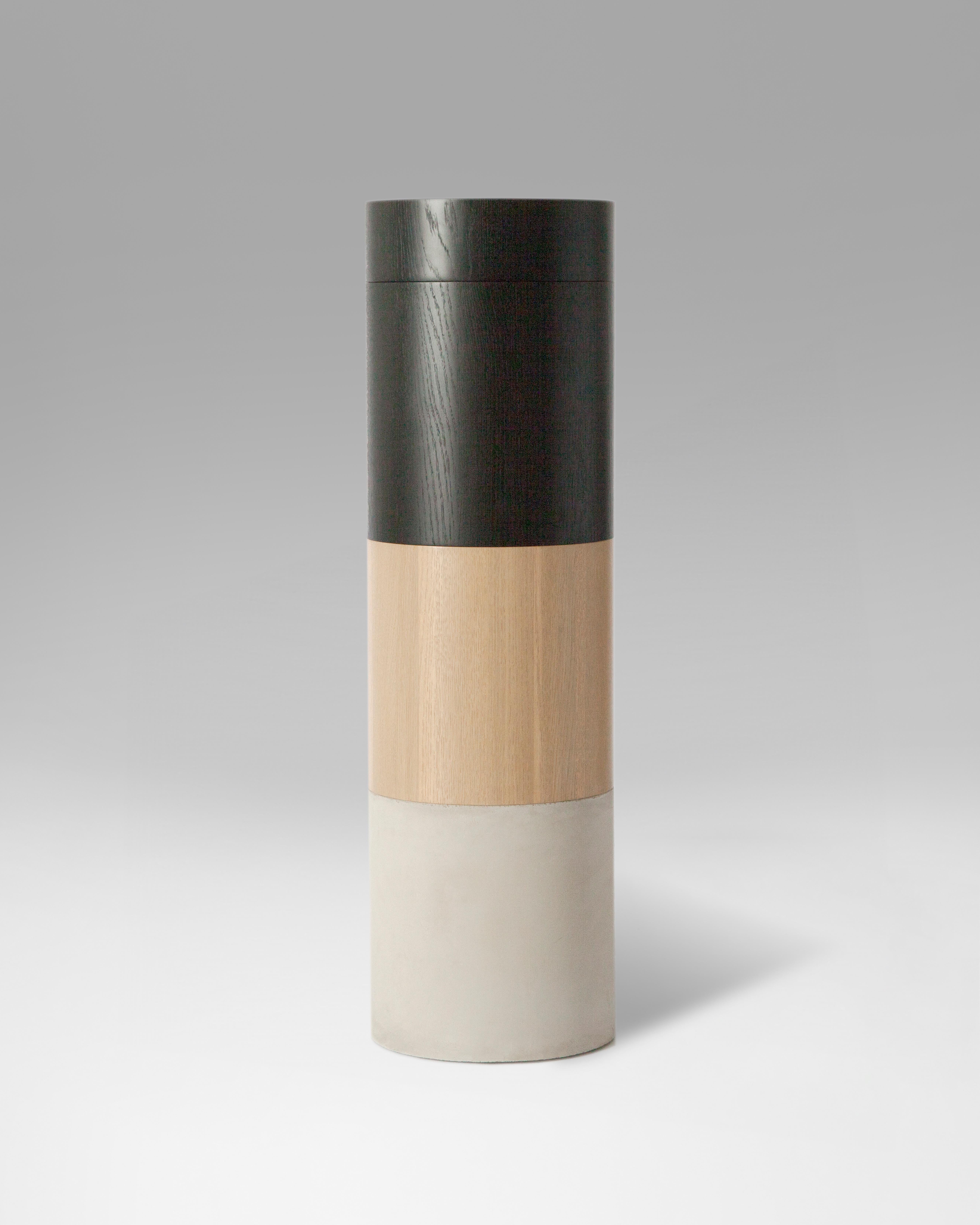 TOTEM is an sculptural looking piece, formed by four different elements: two stackable wooden stools, a heavy concrete base and a wooden top tray. 

Both stools and the tray are made of white oak. One finished with wax, the other one stained in