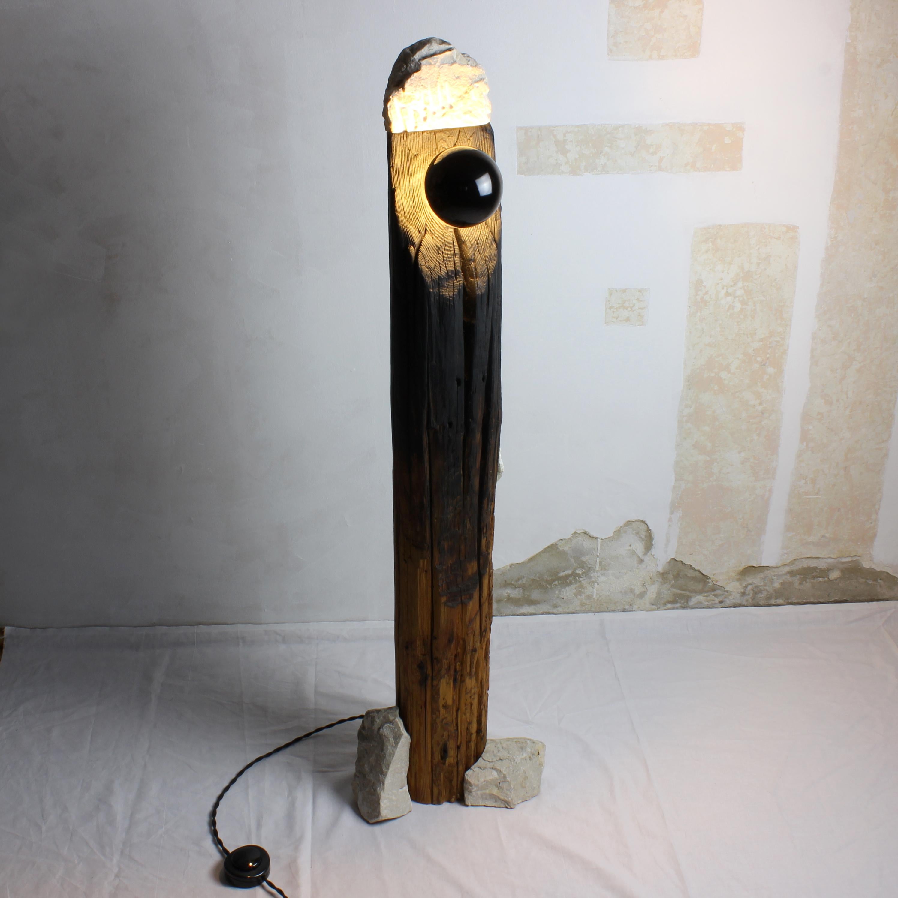 Diese einzigartige Stehlampe ist aus wiederverwendeten Holzsäulen und weißen Steinresten gefertigt und stellt eine stimmungsvolle Kunstskulptur dar. Die Verkabelung ist neu. Aus diesen MATERIALEN neue Objekte zu kreieren, ist die eigentliche