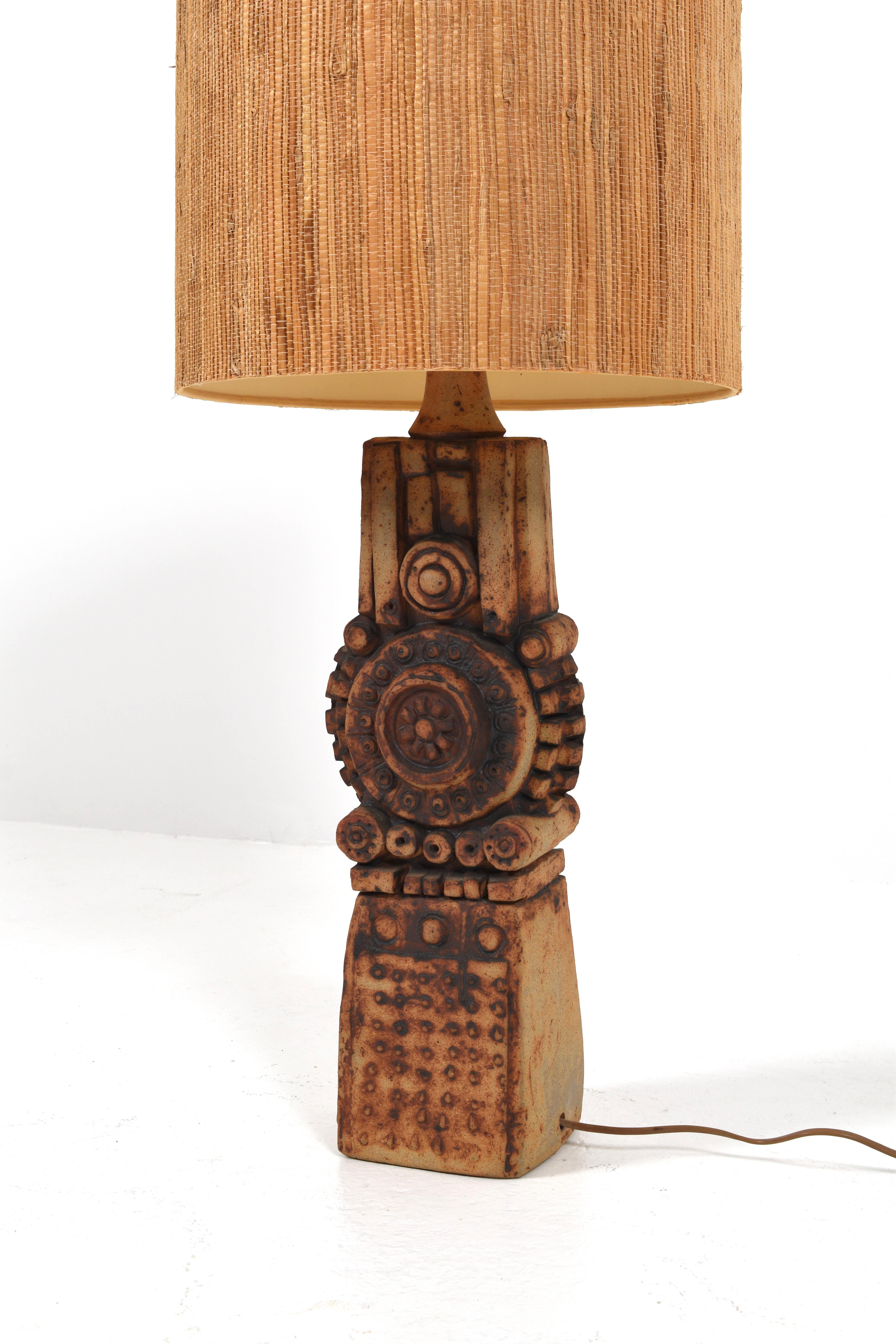 The Totem Table Lamp by Bernard Rooke, crafted in the 1970s, is a striking embodiment of artistic ingenuity and functional design. Created within the confines of Studio Stoneware, this lamp is a testament to Rooke's mastery of ceramics and his