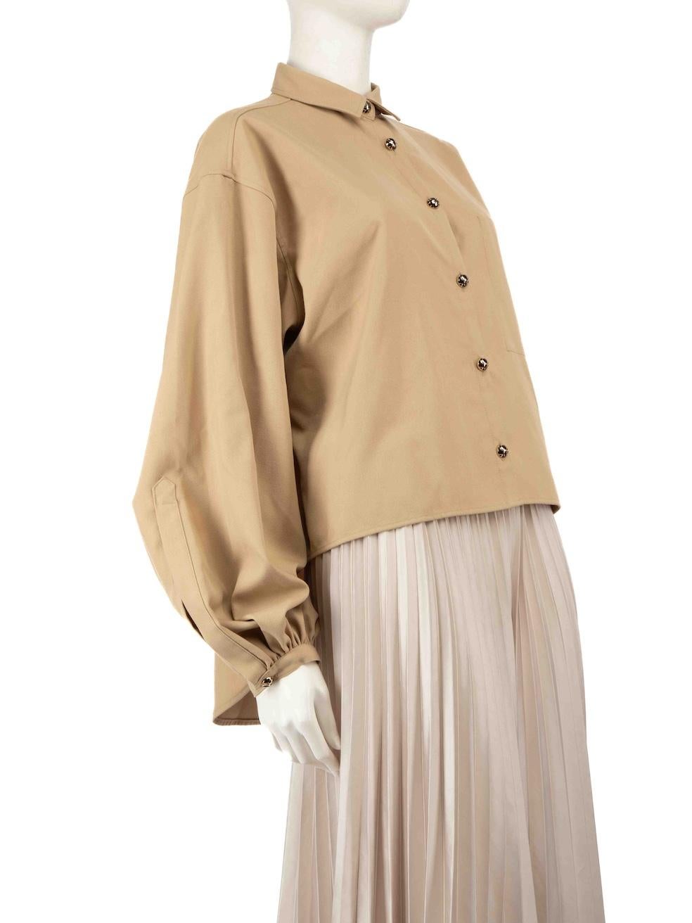 CONDITION is Very good. Minimal wear to the shirt is evident. The brand label is discoloured on this used Totême designer resale item.
 
 Details
 Beige
 Polyester
 Shirt
 Long sleeves
 Buttoned cuffs
 Button up fastening
 Logo buttons
 Oversized
