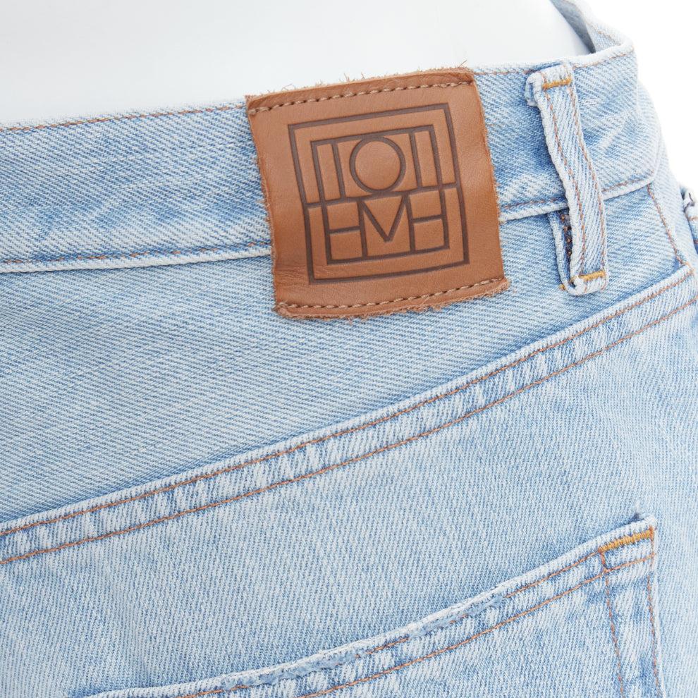 TOTEME Twisted Seam light blue washed denim asymmetric jeans 27