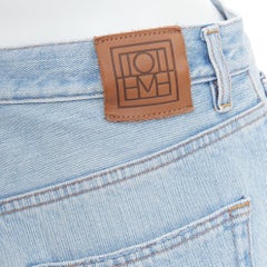 TOTEME Twisted Seam light blue washed denim asymmetric jeans 27"
