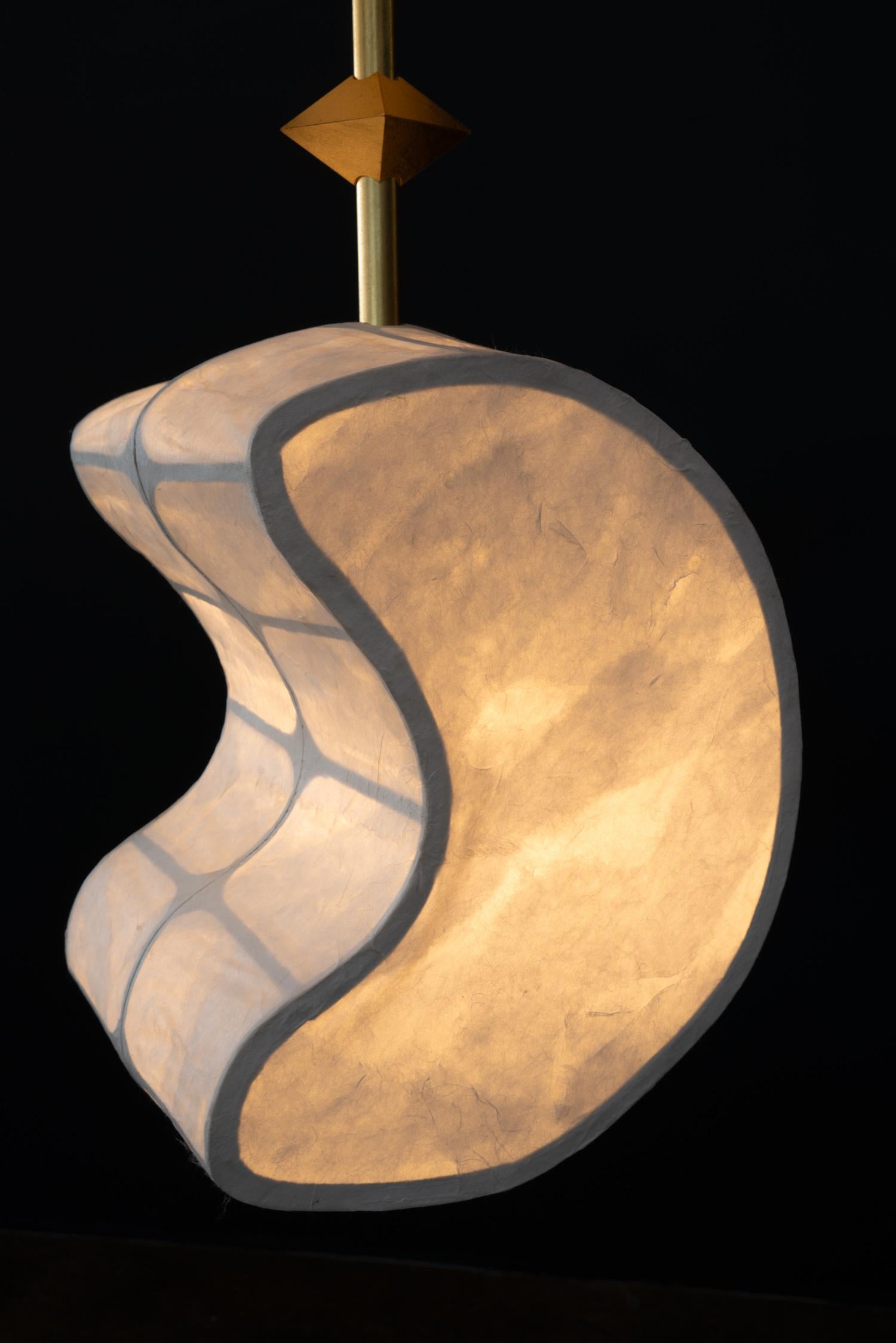 The Totemic Pendant 2(2) is a pendant chandelier with two paper shades (August 10.5, Moon 12 ) and 2 Diamonds.

Totemic is Andrea Claire Studio’s latest lighting collection.  Across cultures, totems serve as vessels of meaning, passed through