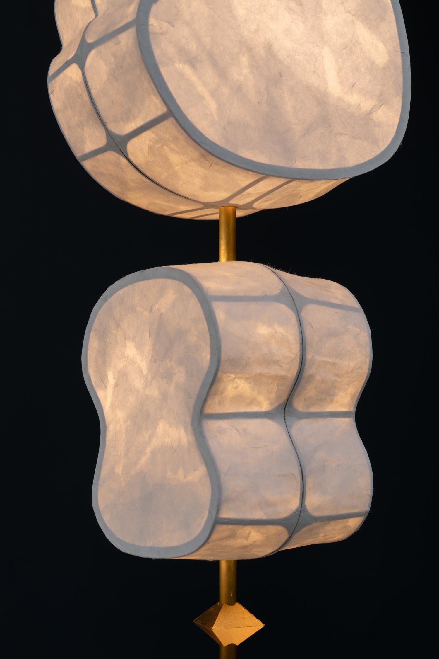 The Totemic Pendant 5(4) is a pendant chandelier with 5 Hanji paper shades (Sage 12, Moon 10.5, August 12, Sage 10.5, August 10.5) and 4 diamond beads.

Totemic is Andrea Claire Studio’s latest lighting collection.  Across cultures, totems serve as