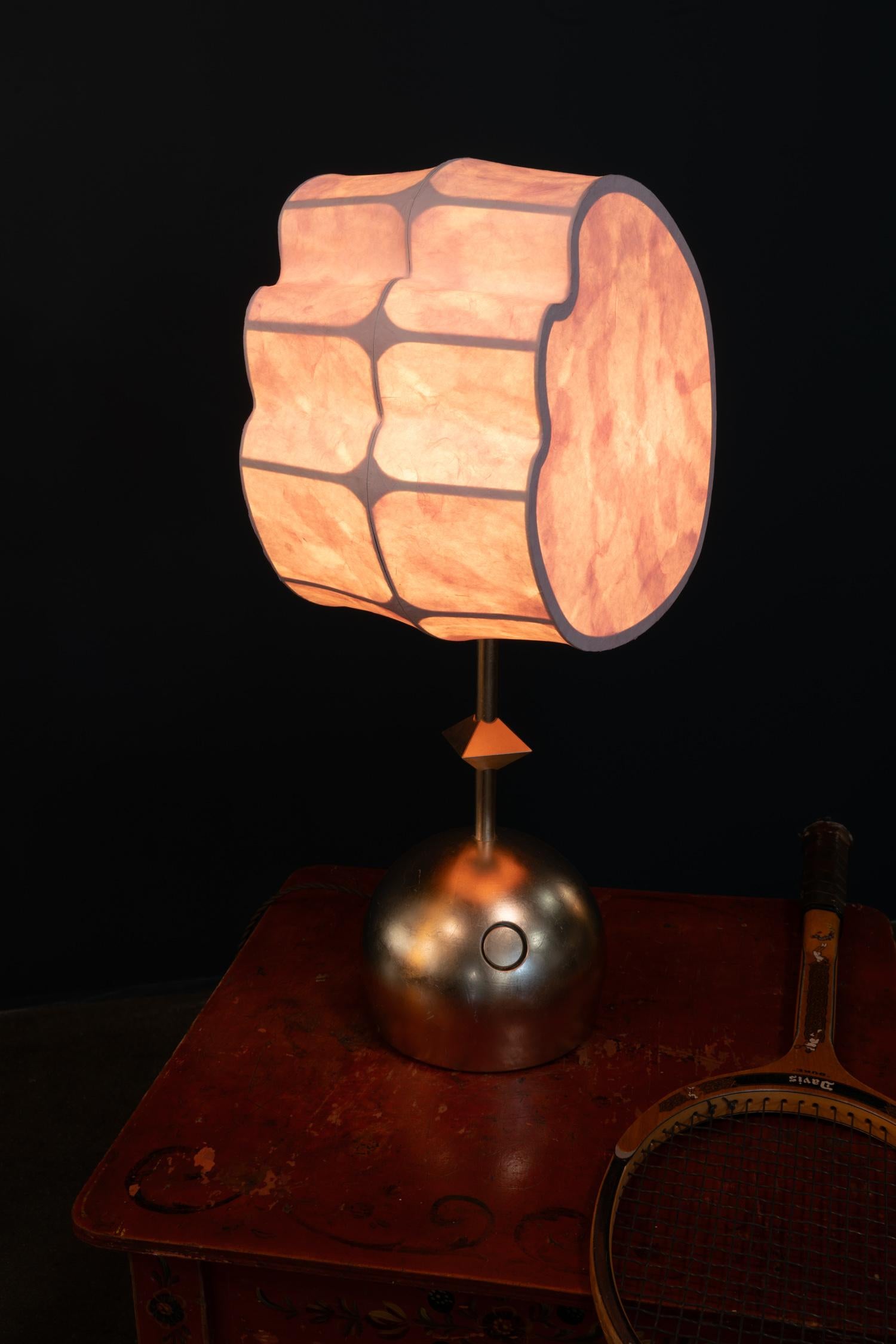 The Totemic Table 1(1) is a pendant chandelier with one paper shade (August 12) and one diamond. The item in stock comes in Rose Watercolor Hanji and Moon Gold Leaf on brass. 

Totemic is Andrea Claire Studio’s latest lighting collection.  Across