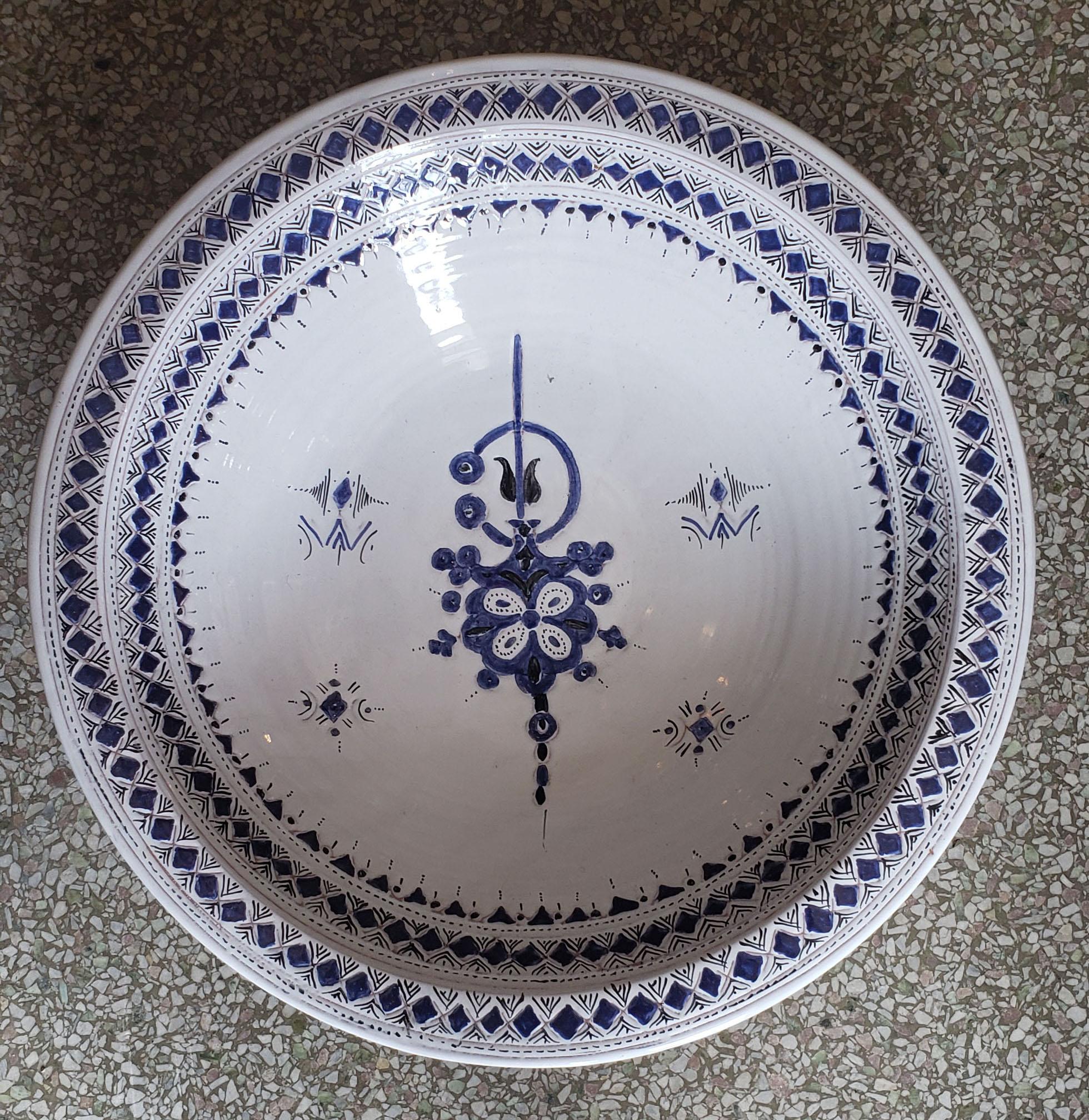 A rare or one of a kind exquisite Moroccan plate / charger for decoration purpose only. This plate is hand painted in blue and white, and inlaid with metal. This plate would be a great add-on to any décor. Great Handcraftsmanship and precision,