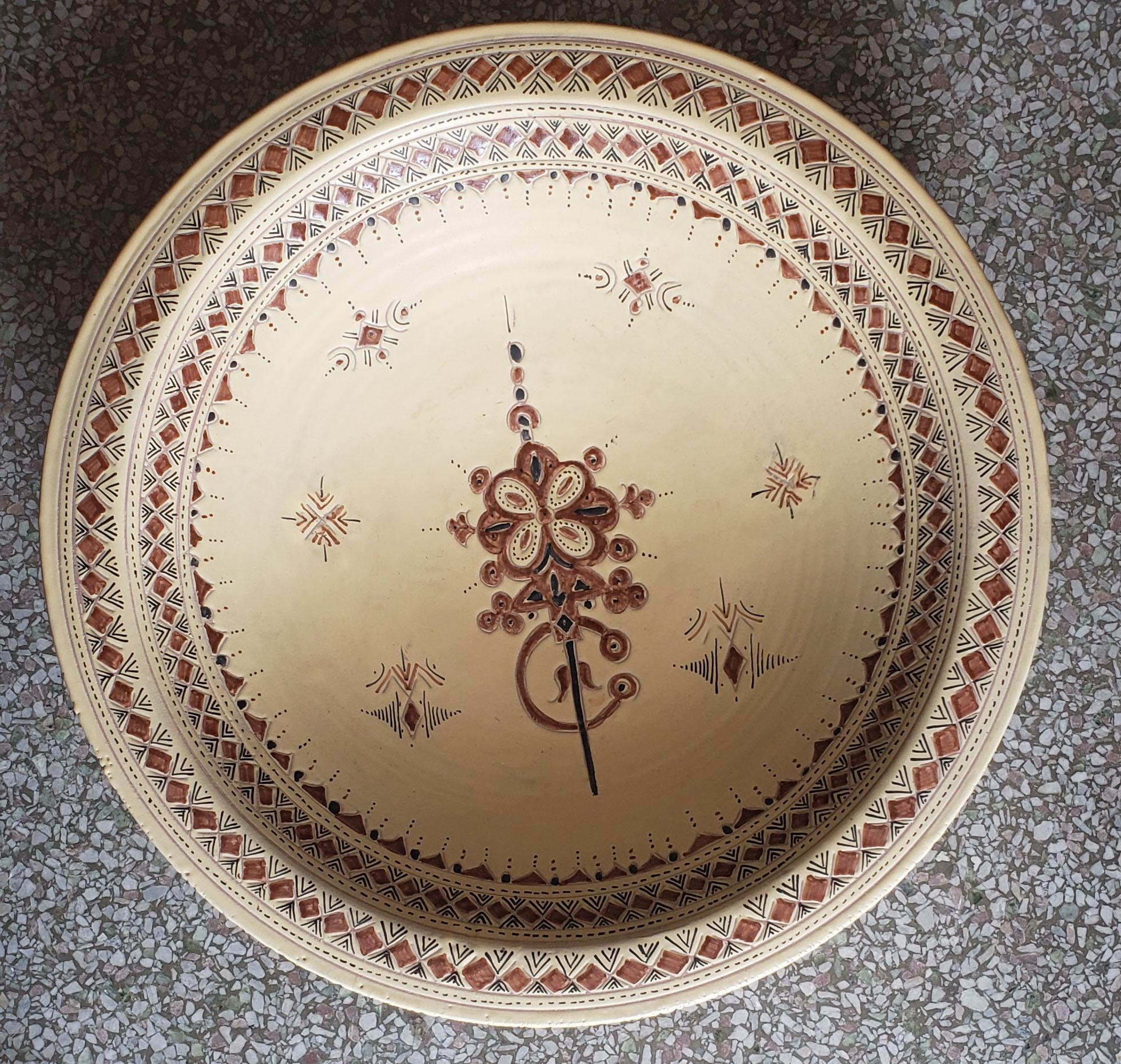 A rare or one of a kind exquisite Moroccan plate / charger for decoration purpose only. This plate is hand-painted in beige and brown. This plate would be a great add-on to any decor. Great Handcraftsmanship and precision, featuring the famous
