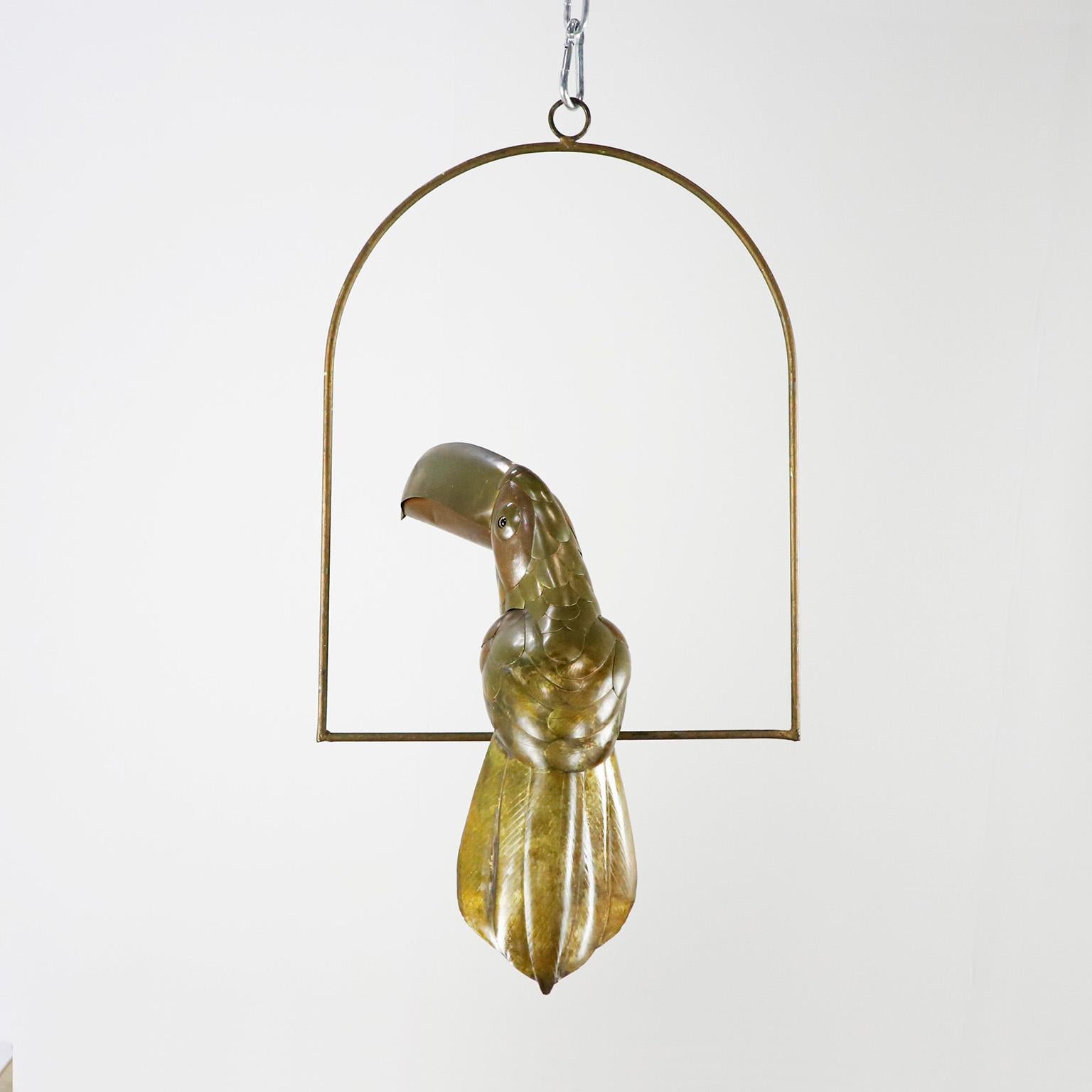 Copper, brass and aluminium Toucan on a hoop hanging stand by Sergio Bustamante, circa 1960. presents some damages.

Sergio Bustamante is a Mexican Artist and sculptor. He began with paintings and papier mache figures, inaugurating the first exhibit