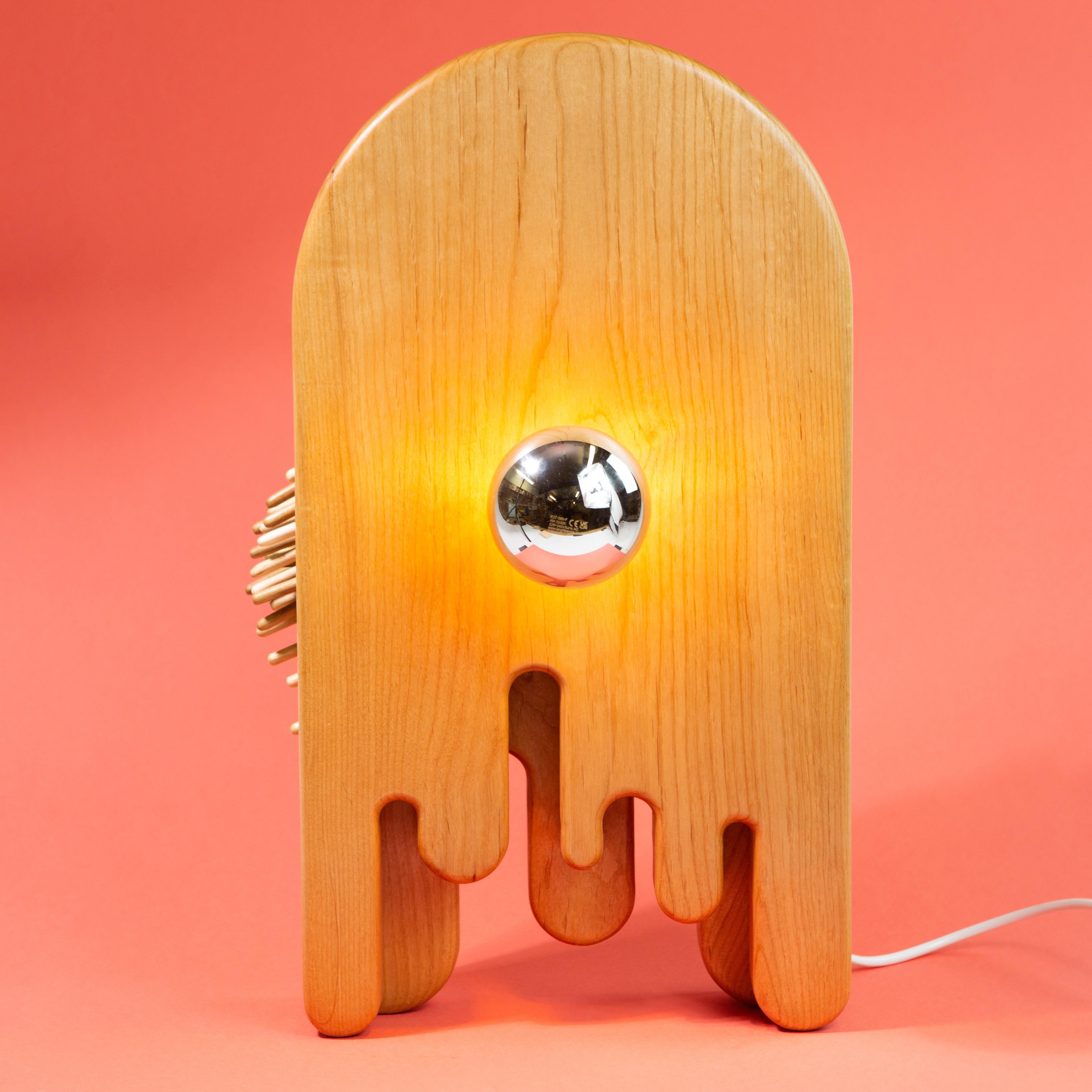 Touch sensitive lamp. Alder body with brass, birch, oak and maple cilia. 