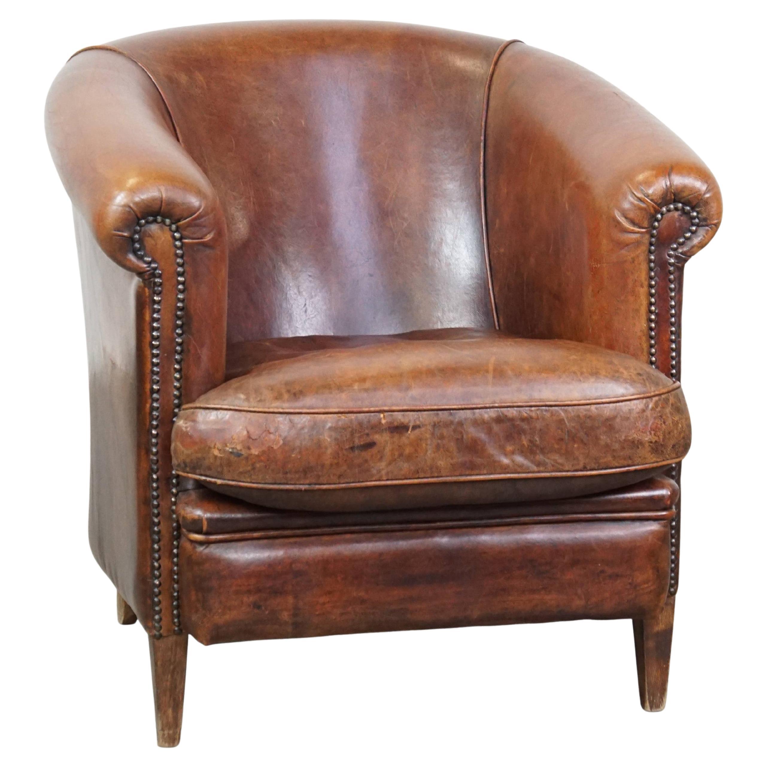 Tough, characterful, and comfortable cognac-colored sheepskin club armchair For Sale