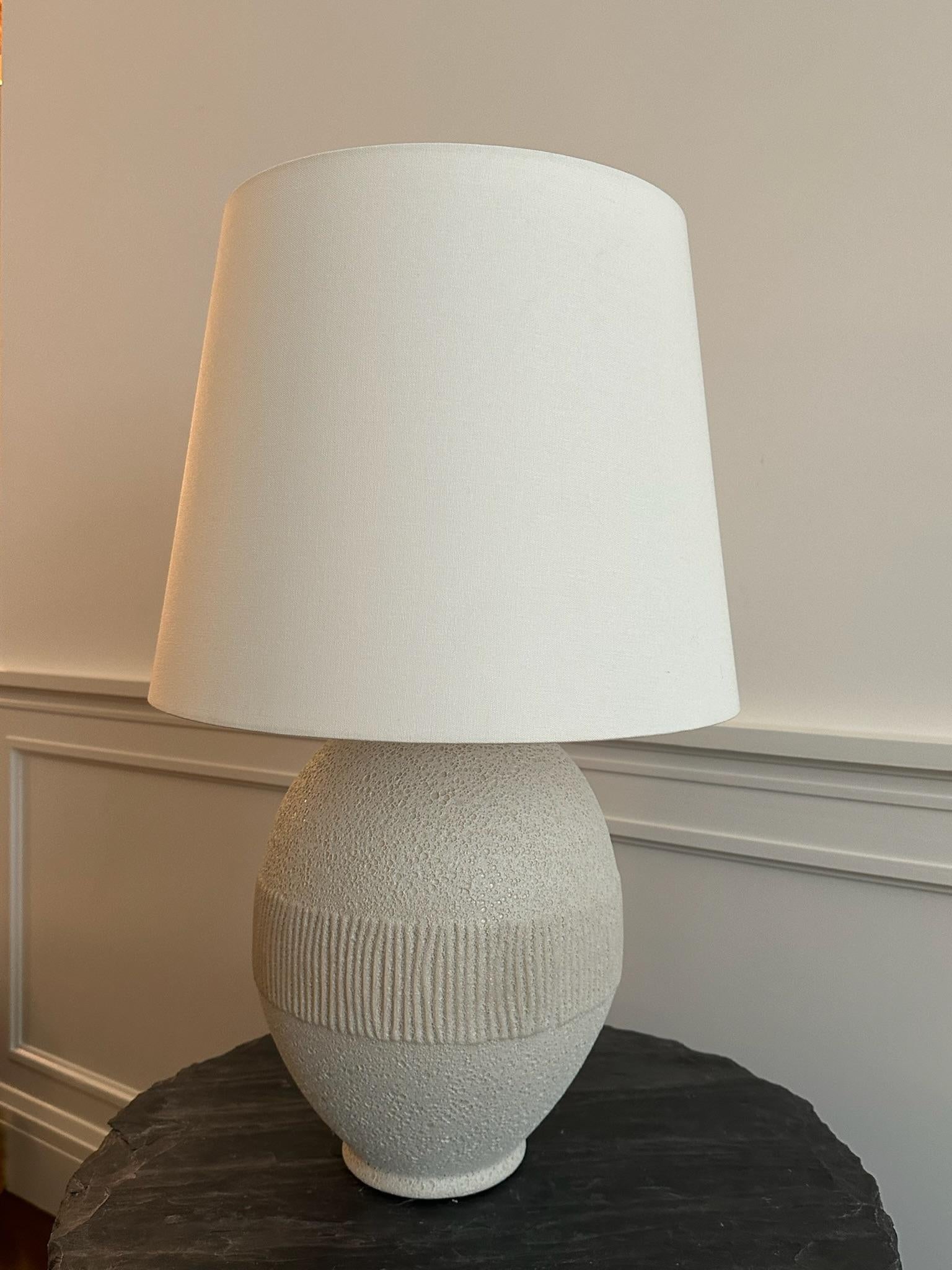 Textural ceramic table lamp, finished with solid brass hardware and a classic linen shade. Aerin collection for Visual Comfort. 