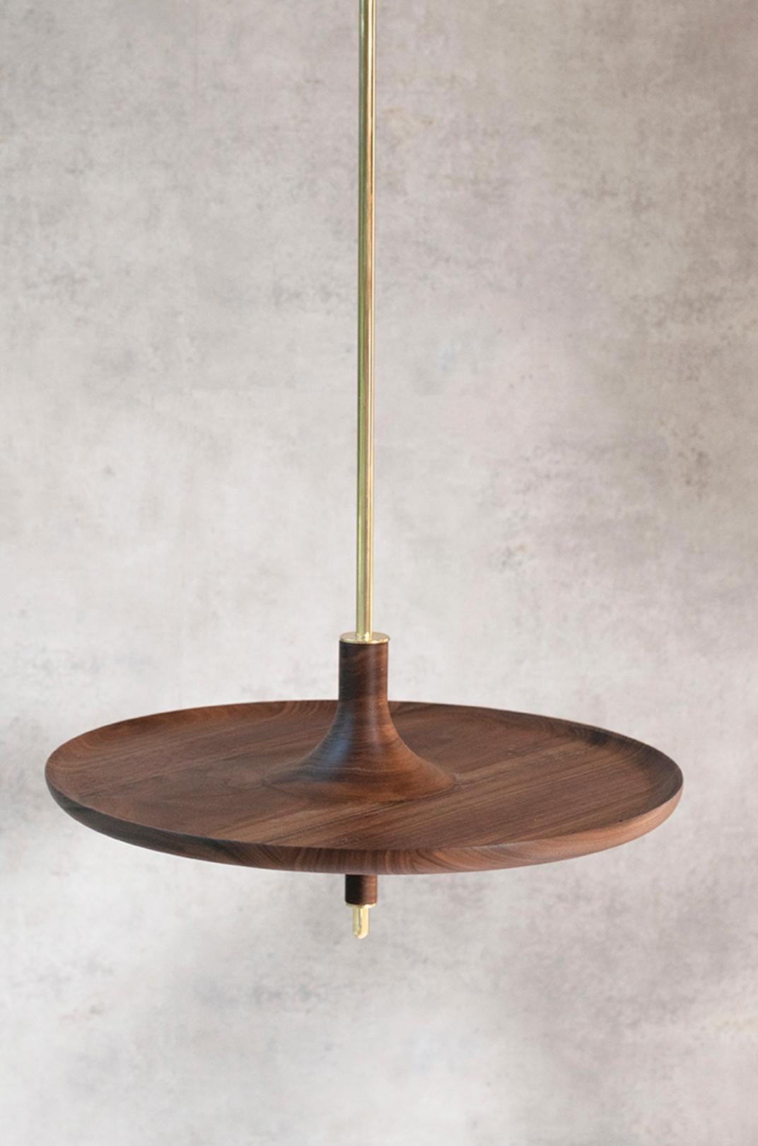 Toupy Walnut And Brass 38 Hanging Table by Mademoiselle Jo
Dimensions: Ø 38 x H 150 cm.
Materials: Walnut wood and brass.

Available in four colors, two bar versions and several diameters. Please contact us. 

Taking the shape of a wooden spinning