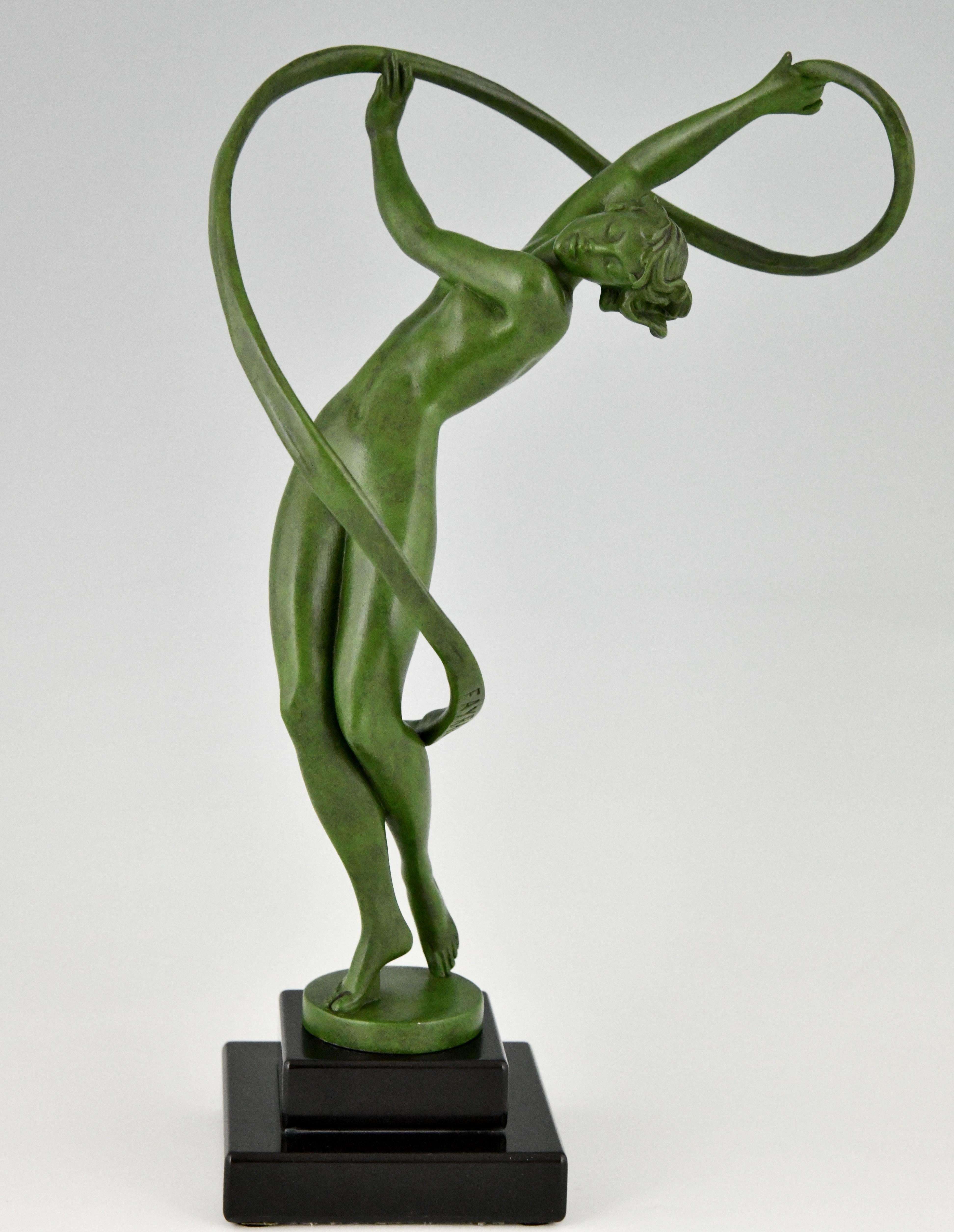 Tourbillon, elegant Art Deco sculpture of a nude dancer with swirling ribbon by Fayral, pseudonym of Pierre Le Faguays.
Cast at the Max Le Verrier foundry in Paris, ca. 1930. 
The Art metal sculpture has a green patina and stands on a black marble