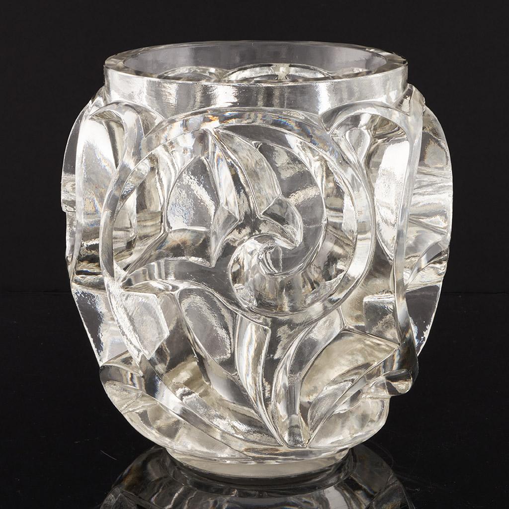 Tourbillons, an Art Deco glass vase. clear and frosted press moulded glass, decorated over with a stylised, geometric design of fern blossom. 

Literature: Marcilhac, R Lalique Catalogue Raisonné de L’Œuvre de Verre p.433

Dimensions: H 20cm D 15cm