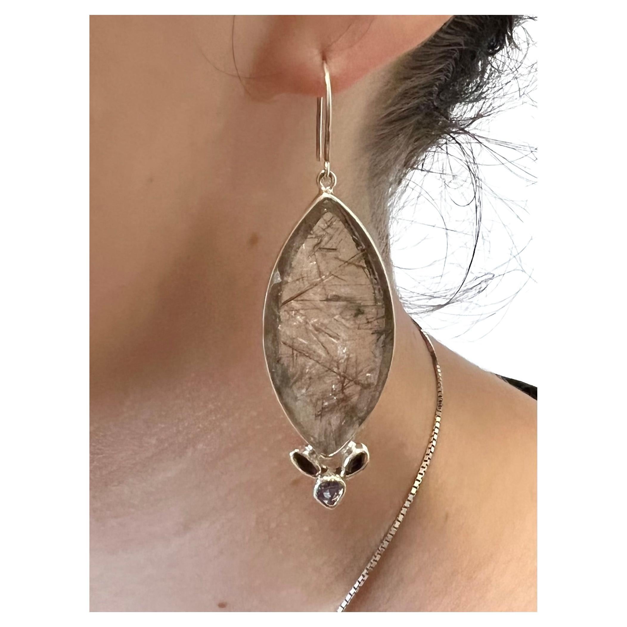 These earrings are one of our original designs. We collaborate with a master silversmith in Kotegeti, Java, the heart of the silver industry in Indonesia, to create these one of kind pieces. The beautifully translucent quartz with long, narrow