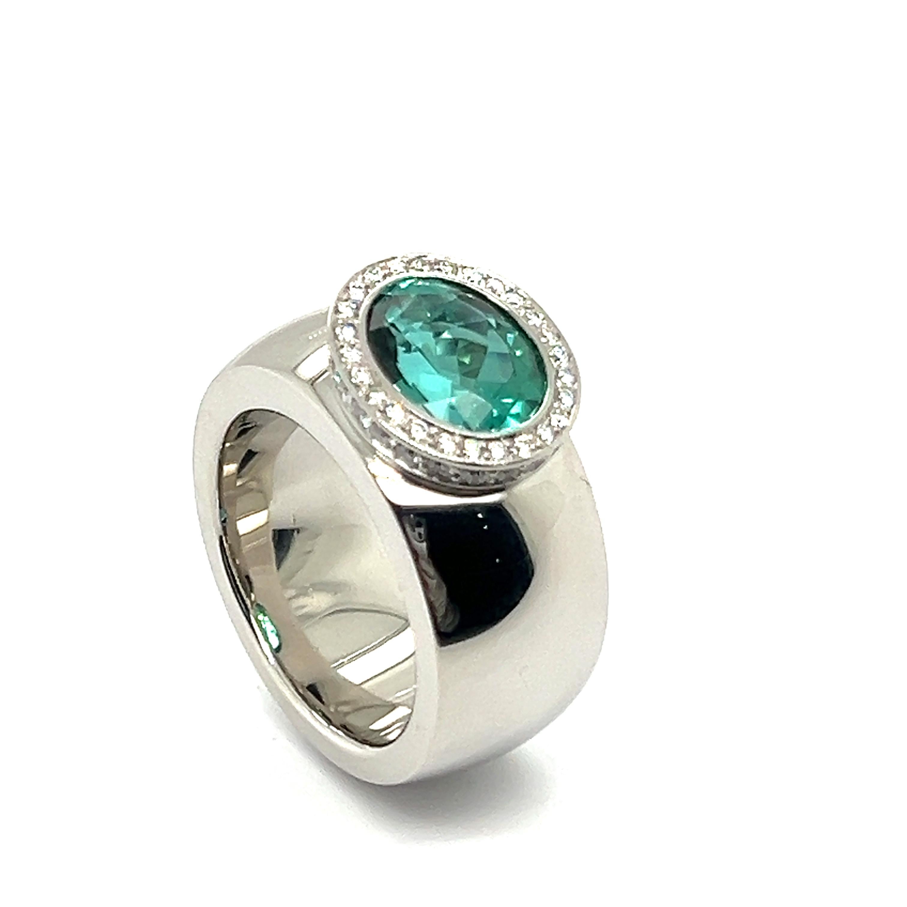 Behold a captivating statement ring by the visionary designer Jochen Pohl. Crafted in fine platinum, its thick band exudes strength and elegance simultaneously. 

At its heart lies a mesmerizing oval-cut tourmaline, weighing 3.96 carats and