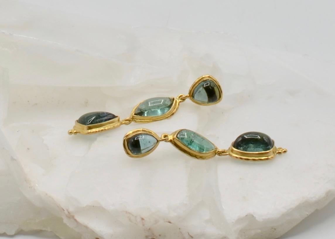 These deep blue peacock Steven Battelle designed tourmaline earrings are beautifully matched in color and shape to create a stunning pair of 18 karat gold earrings that can be worn every day. The neutral green is compatible with any color you choose