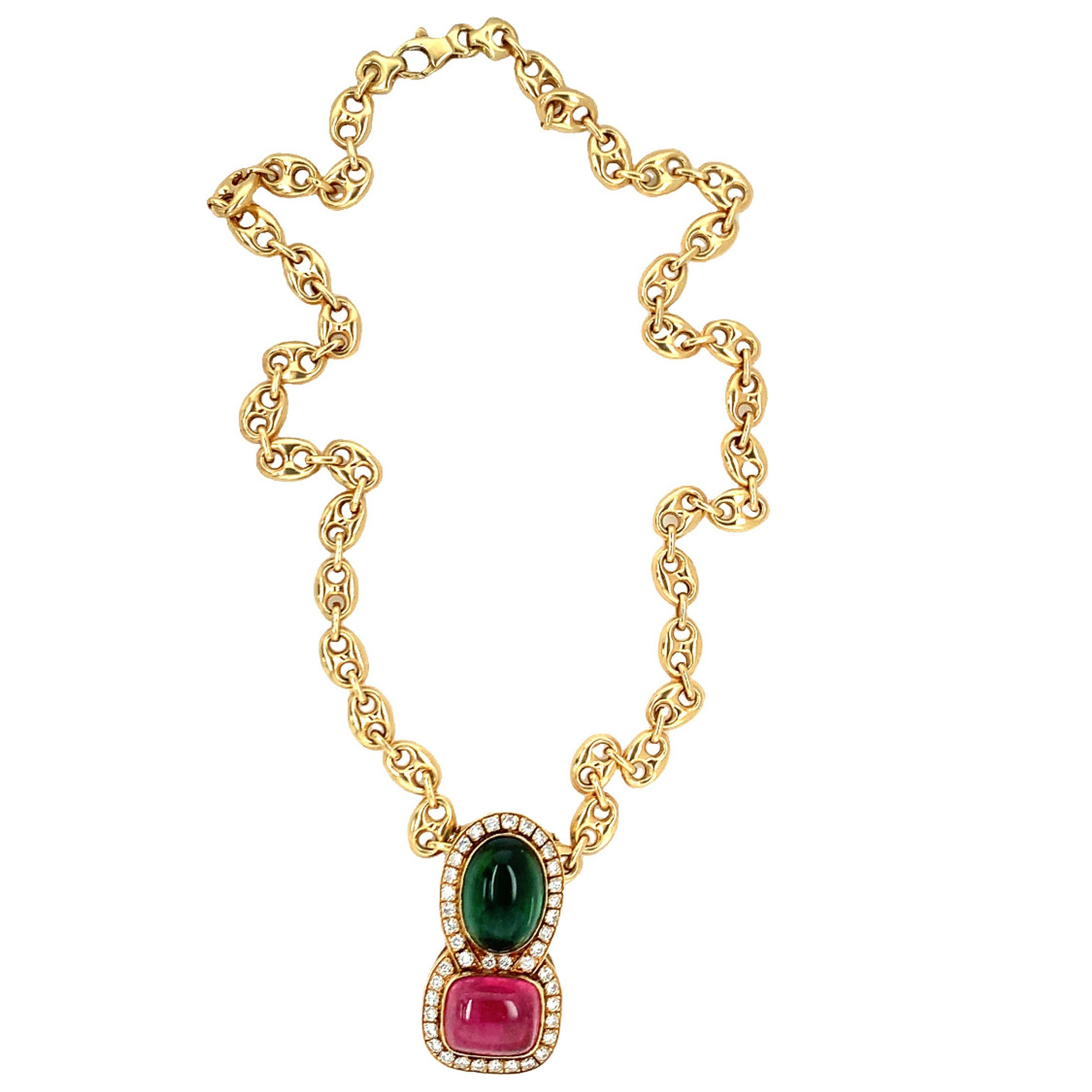 One stacked pink and green tourmaline and diamond 18K yellow gold pendant featuring one rectangular cabochon pink tourmaline weighing 12 ct. and one oval cabochon green tourmaline weighing 15 ct. Enhanced by 41 round brilliant cut diamonds weighing