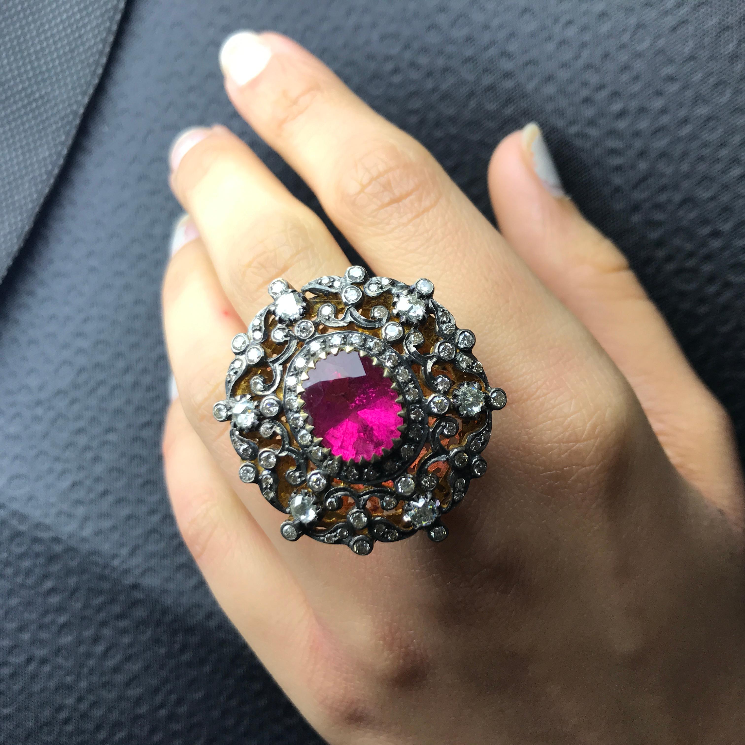 A stunning, antique-looking Tourmaline (around 6 carats) and Diamond cocktail ring all set in Silver and Gold. The centre stone is transparent, with very few inclusions, and great cut, hence there is ample of lustre in the stone. It is currently