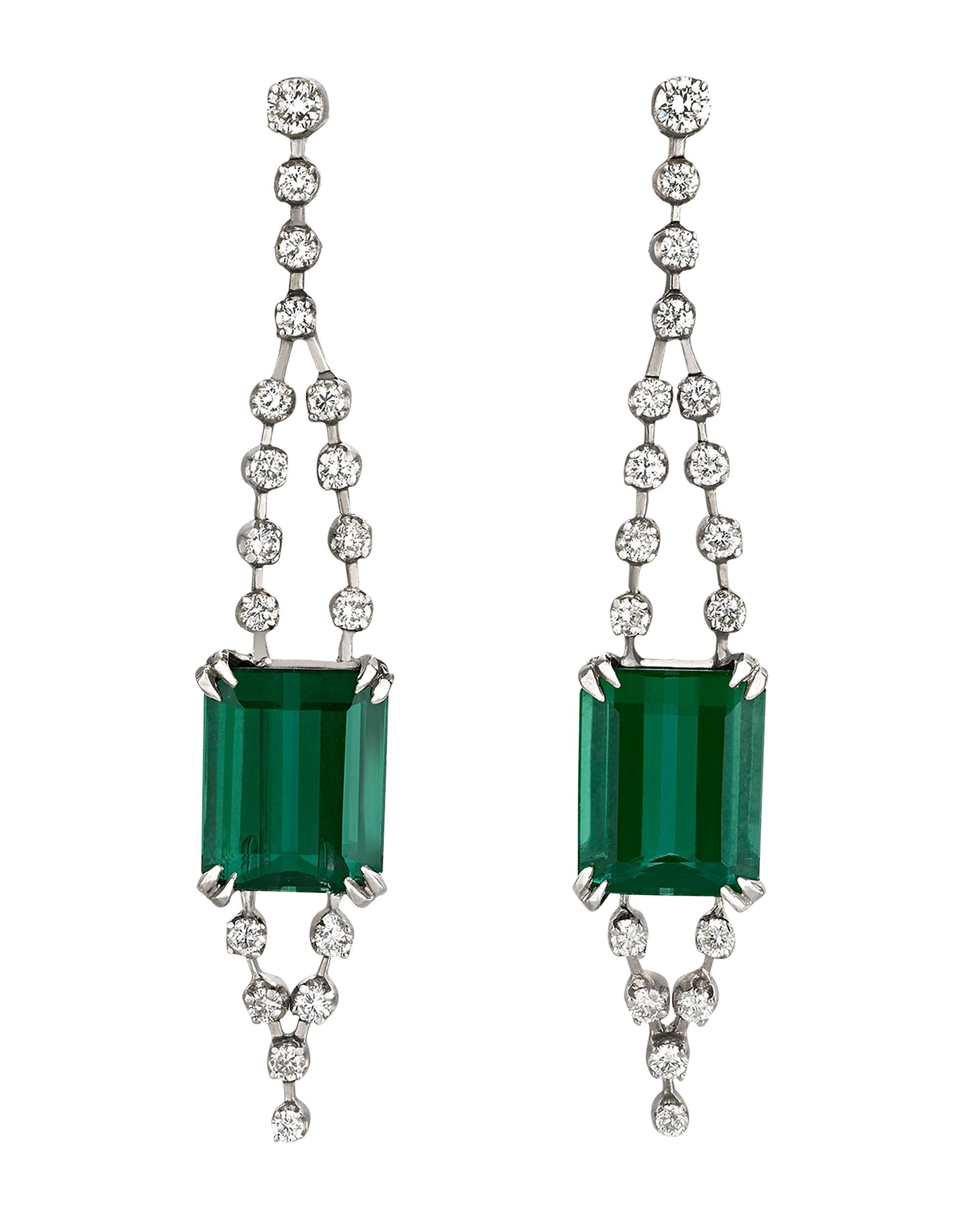 Brilliant and bold, two rare emerald-cut green tourmalines totaling approximately 7.00 carats dazzle beyond measure in these elegant drop earrings by H. Stern. Displaying an attractive deep blue-green hue, these stones represent the tourmaline at