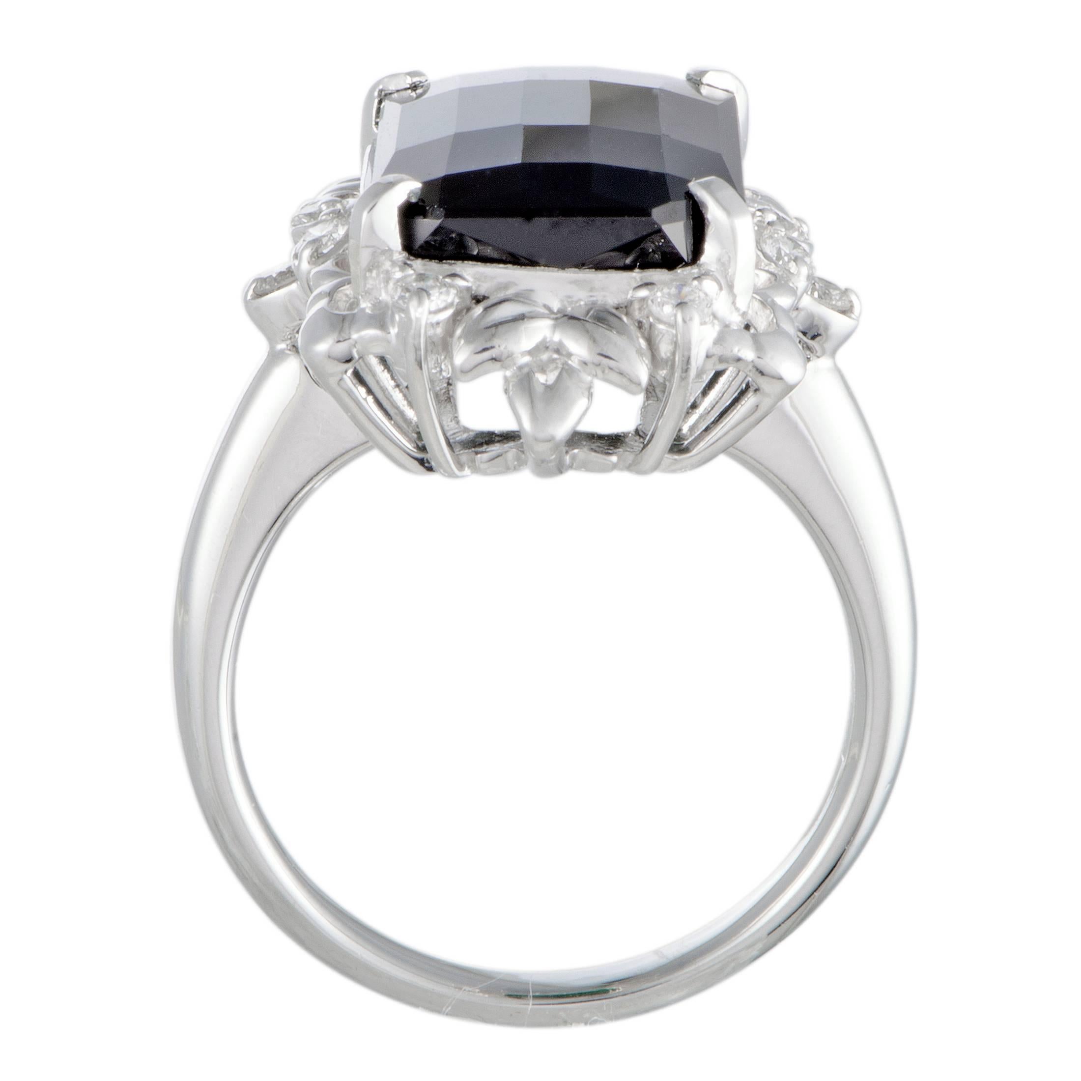 Boasting an irresistibly intricate design and set with an exquisitely cut gemstone, this stunning platinum ring offers a look of utmost refinement and prestige. The center stone is an astonishing green tourmaline that weighs 7.10 carats and is