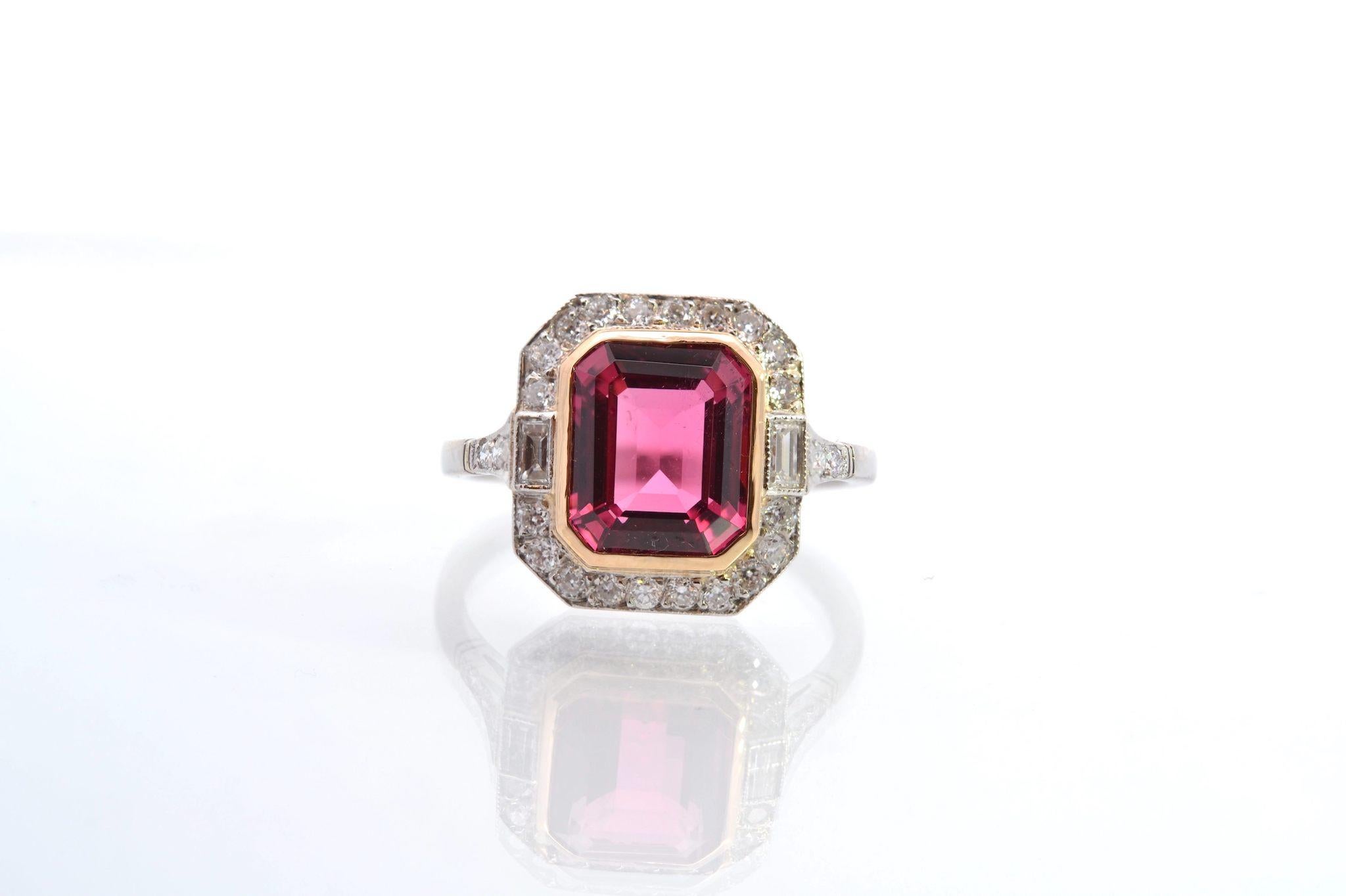 Stones: 1 pink tourmaline of 2.88cts, 26 diamonds: 0.40ct, 2 baguette diamonds: 0.10ct
Material: Platinum and yellow gold setting for the tourmaline
Dimensions: 1.3cm x 1.2cm
Weight: 4.7g
Period: Recent vintage style (handmade)
Size: 53 (free