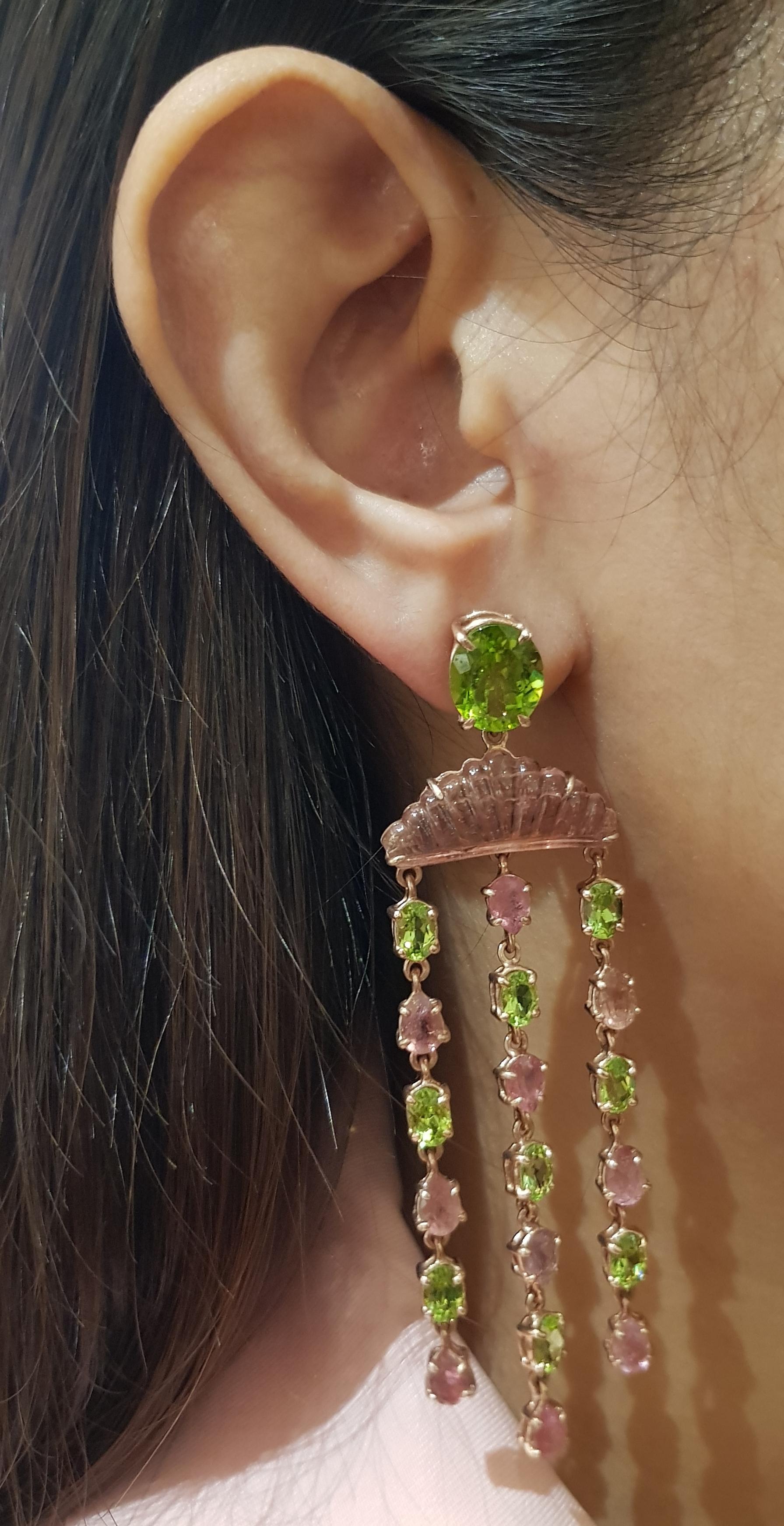 Tourmaline and Peridot Earrings set in Silver Settings

Width:  2.4 cm 
Length: 8.8 cm
Total Weight: 23.89 grams

*Please note that the silver setting is plated with gold and rhodium to promote shine and help prevent oxidation.  However, with the