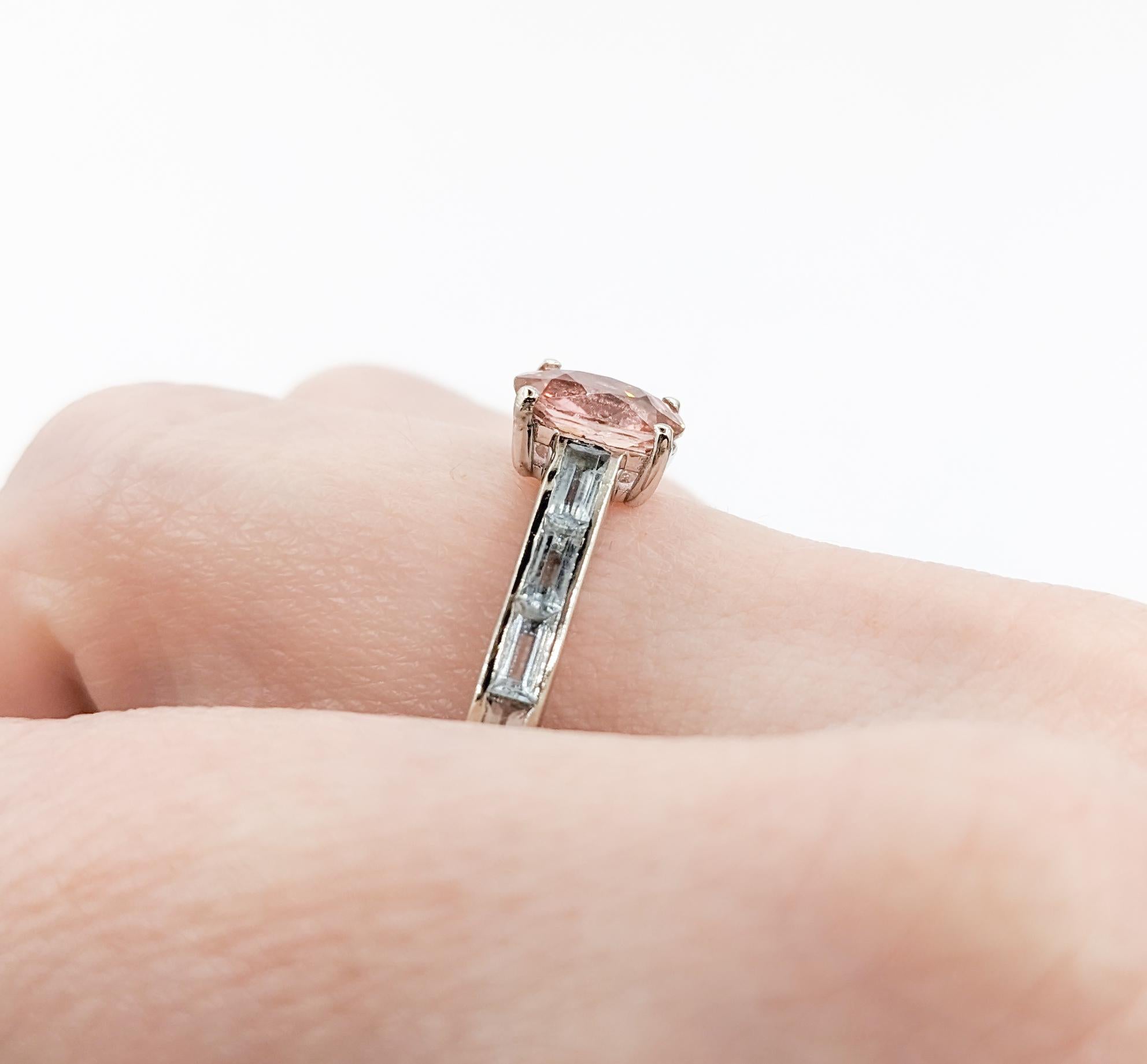 Custom Tourmaline & Aquamarine Ring in White Gold

Embrace the allure of color with our stunning ring, expertly crafted in the timeless beauty of 14k white gold. This exquisite piece showcases a captivating 1.4 carat oval pink tourmaline, renowned