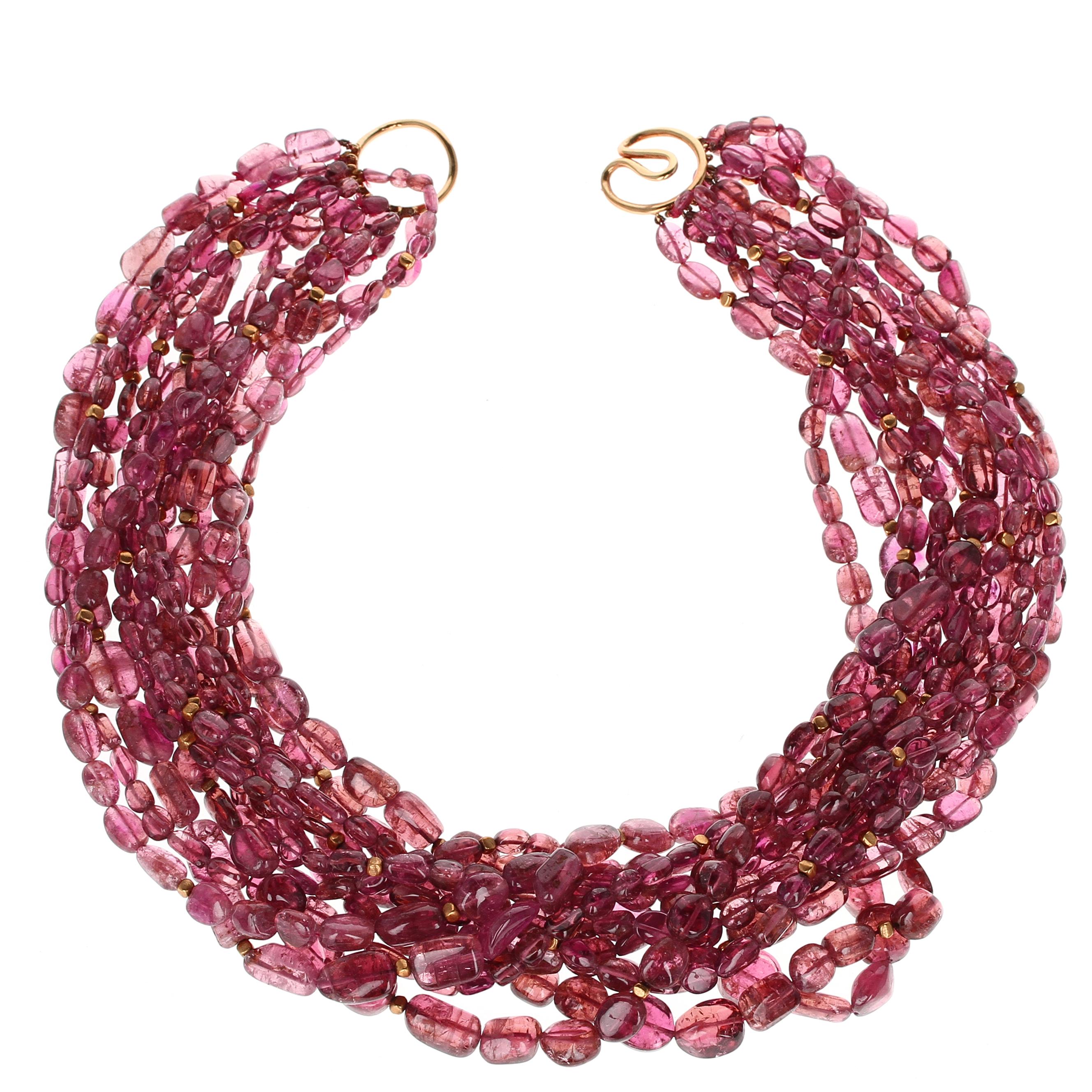 A simple and classic tourmaline bead necklace set with an 18kt yellow gold clasp; the total weight of the necklace is approximately 1,200 carats, the length is 17.5 inches.