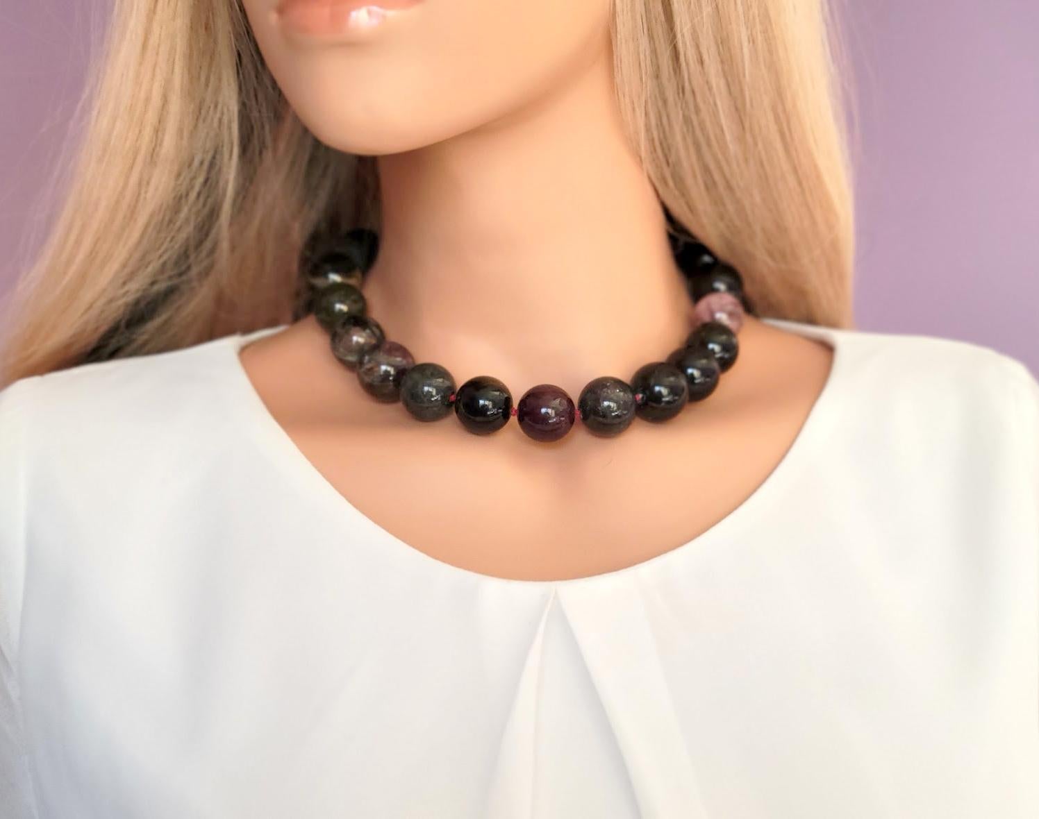 The length of the necklace is 18 inches ( 45.7 cm). The rare huge size of the smooth round beads is 19-20 mm.

Beads are multicolored: black, green, purple, brown, pink, etc. Crystals of tourmaline are green at one end, pink at the other, or green