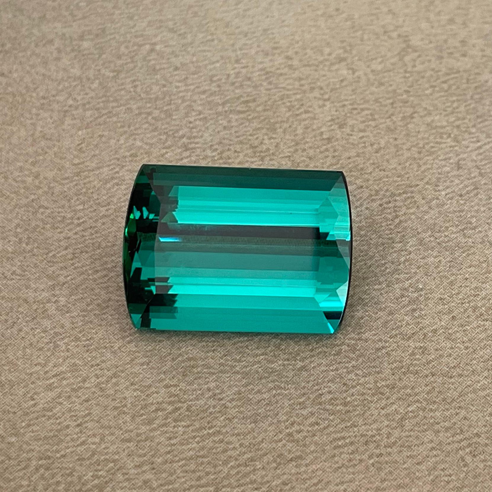 This deep blue-green Tourmaline was mined in Brazil before it made its way into our stock. The large stone boasts 23.07ct in weight and still does not feel heavy. Black reflections are common for Tourmaline in these deep colors; however, we had the