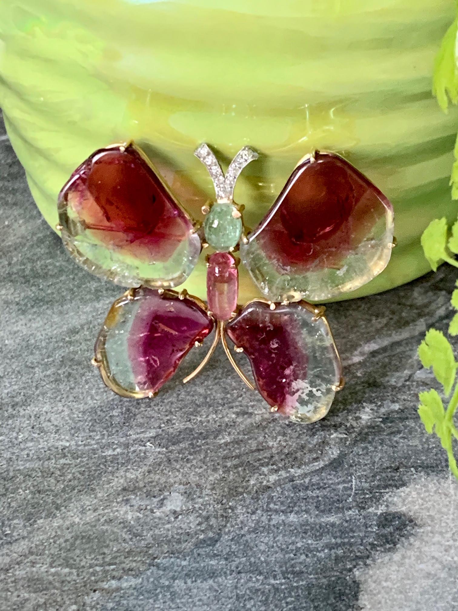 This beautiful butterfly brooch was made circa 1940's-1950's.  It consists of:
4 Watermelon Slice Wings
1 small Green Tourmaline cabochon
1 small oval Pink Tourmaline cabochon
9 small European cut diamond Antenna - approximately .25 ctw

it measures