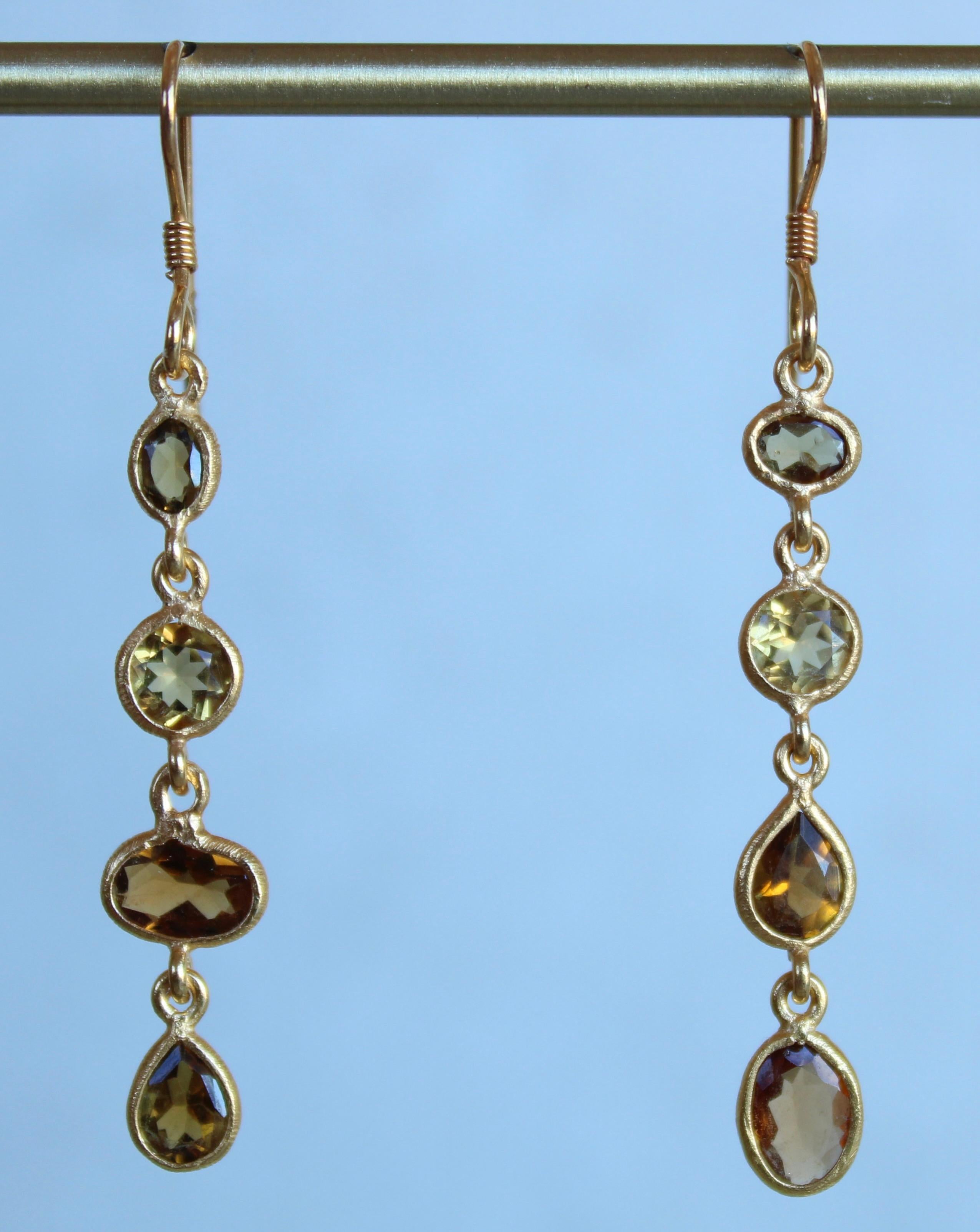 Beautifully appointed and designed four stone dangle earrings comprised of Citrine and Tourmaline. These earrings are meant to be worn as a pair or as a single on either ear. As shown, these dangle earrings are set in 14 karat gold plating with a 14