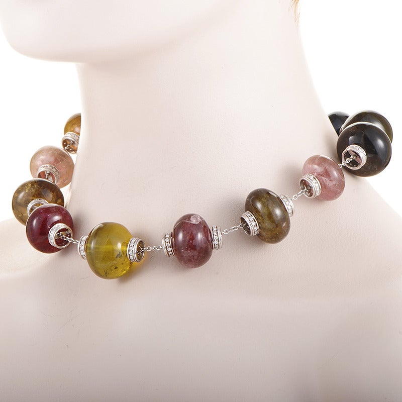 Comprised of numerous tourmaline stones in a number of diverse enchanting nuances, this gorgeous necklace boasts attractive vivacious look; the stones are connected with an 18K white gold chain featuring splendidly crafted elements accented with