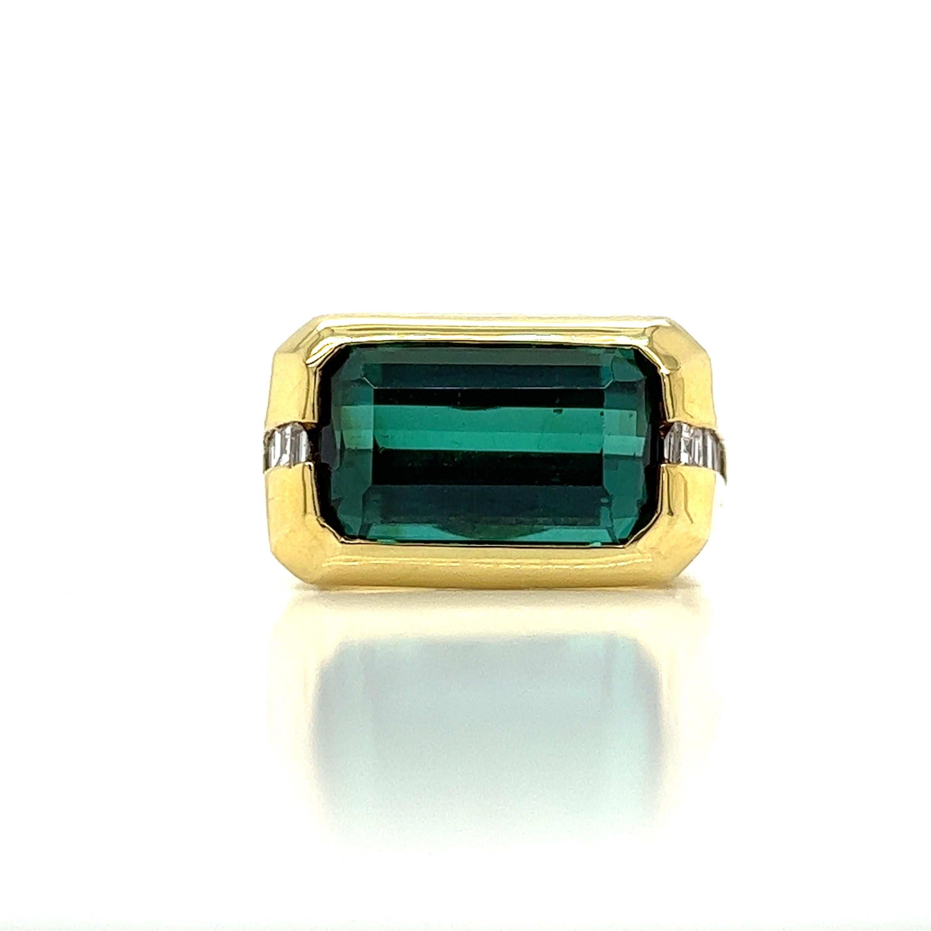 This Vintage 6.97 carat Green Tourmaline and Diamond 18K Gold Ring is the perfect blend of traditional and modern style. It is one of a kind, crafted with 18K gold and emerald cut green tourmaline, set east to west for an estate piece with a