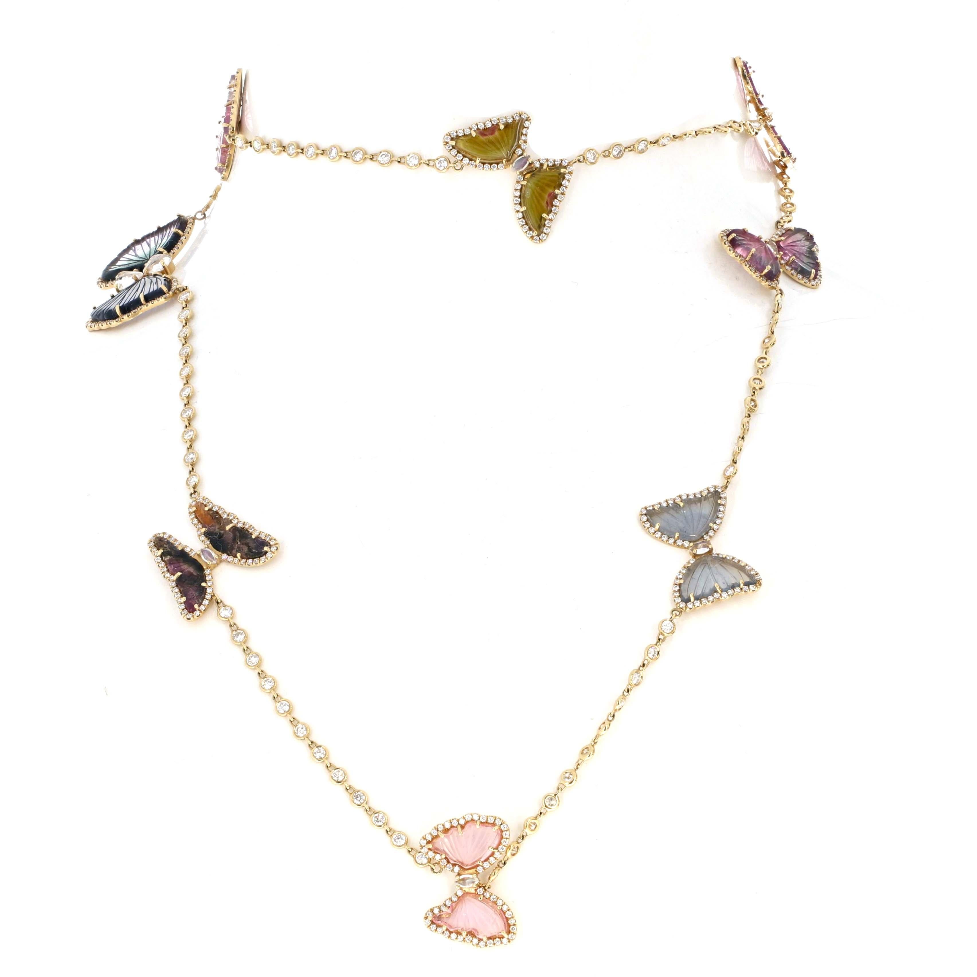 This exquisite 18K yellow gold butterfly necklace is a whimsical yet luxurious statement piece. It showcases intricately carved multicolor tourmaline butterflies adorned with sparkling diamond accents. With 24.27 carats of richly colored tourmaline,
