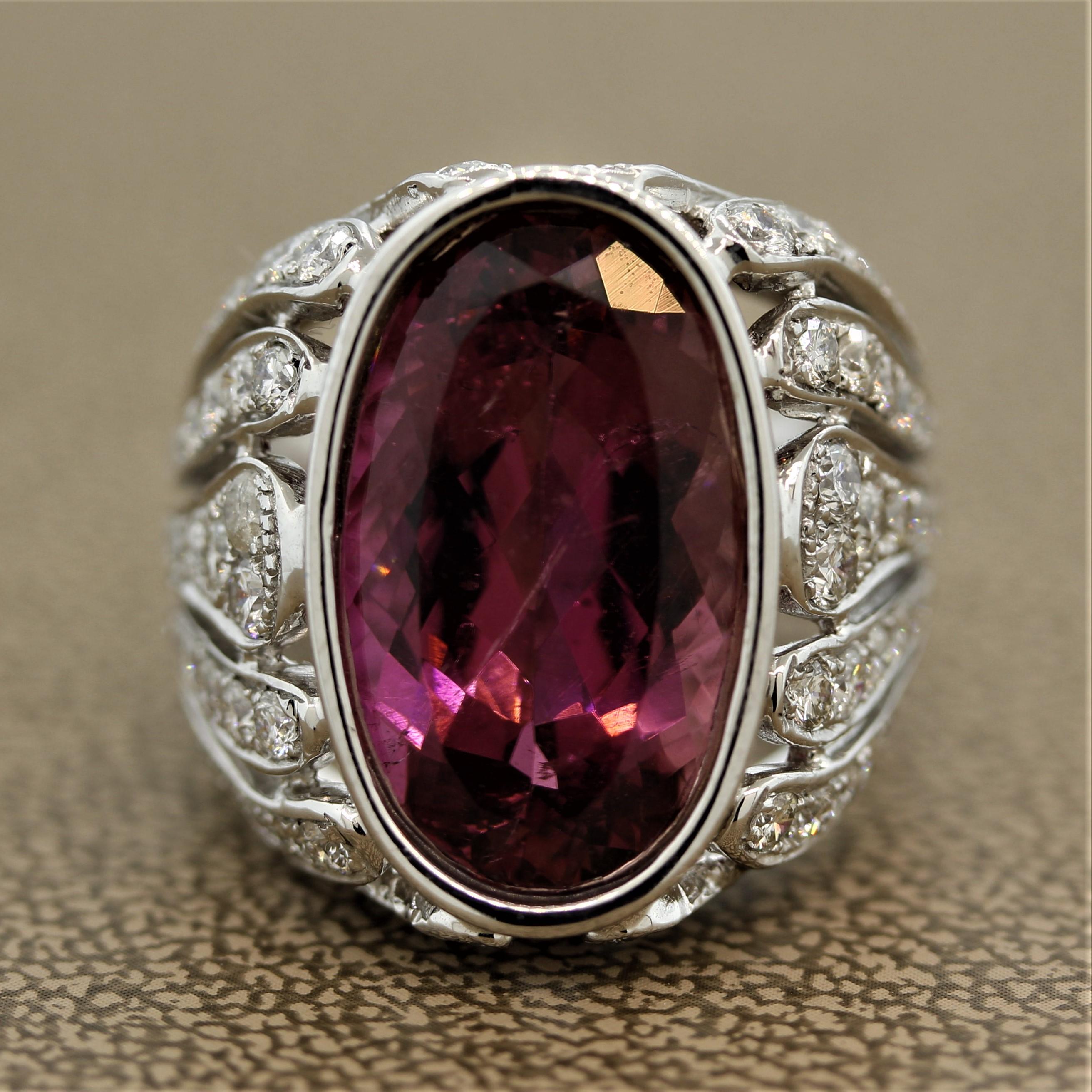 A lovely cocktail ring featuring a 9.30 carat tourmaline. The tourmaline has a vivid pinkish-purple color and shaped as a beautiful oval in a bezel setting. The body of the ring has open gold work in a chic flame pattern which has 2.00 carats of