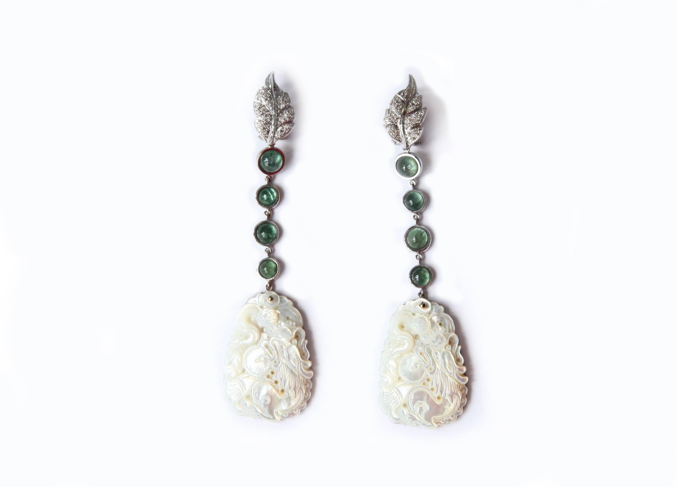 Long earrings total length is 9,5 cm very refined diamond leafs, cabochon green tourmaline, carved mother of pearls reproducing the famous Chinese white dragon.
All Giulia Colussi jewelry is new and has never been previously owned or worn. Each item