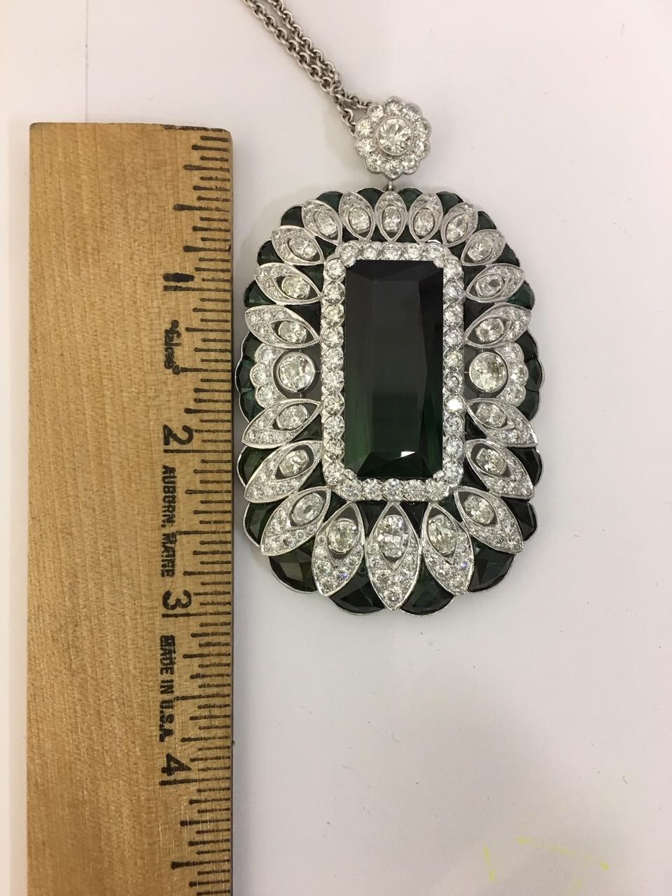 Exclusive hand crafted Tourmaline and Diamonds Pendant set in Platinum. Approx 75 Carat of Green Tourmaline 
( 50 Carat center and 25 Carat around ) Approx  12 Carat other diamonds pendant is one of a kind master workmen ship pendant with
