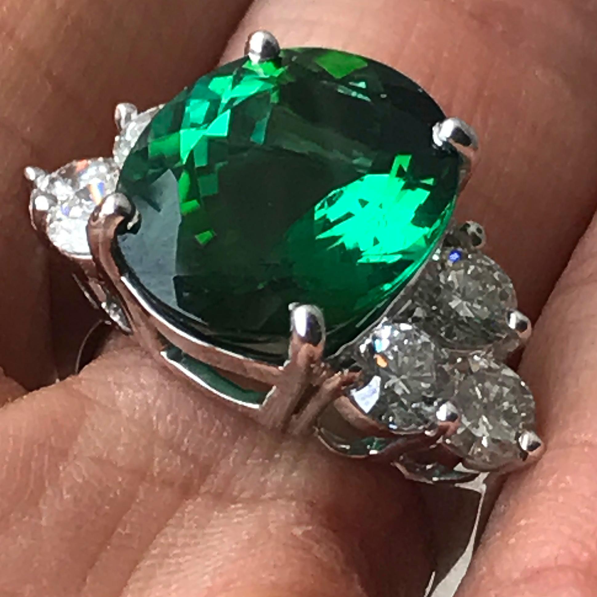 Stunning 9.7 Carat TW Center is an Oval Green Tourmaline set in a hand designed 18k White Gold.

The stone is enhanced three round diamonds on each side.

Stock # B4403018

Center Stone Details: 
Gem Type: Tourmaline
Carat weight:  7.91
Shape: