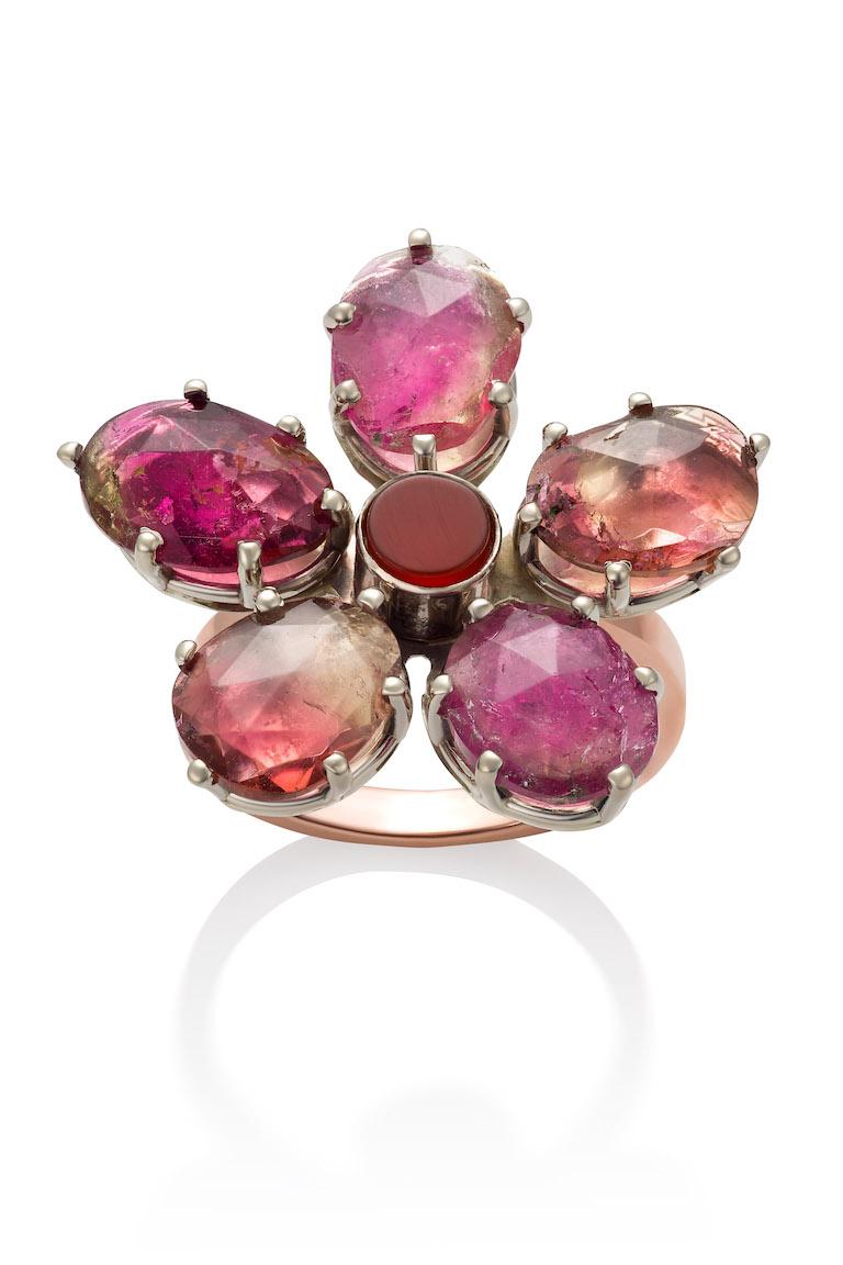 10K rose and white gold flower ring with rose cut tourmaline petals (10.42 CTW) surround a carnelian center.  State of Maine mined rose cut tourmaline pedals are as unique as each flower pedal is in nature. The heavy white gold prongs adds a Steam