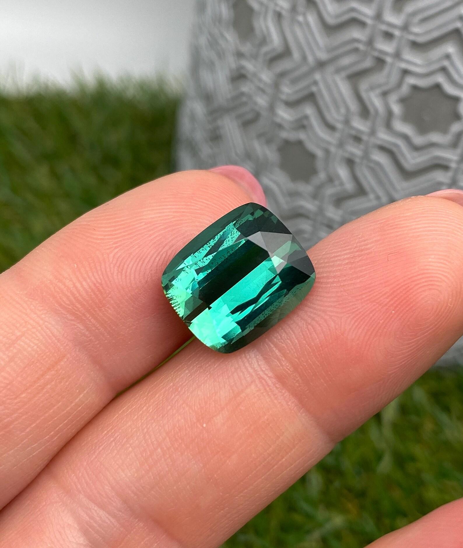 Natural Lagoon Tourmaline gemstone

Certificate GFCO and GIA
Gemstone Color: blue-green
Gemstone Type: Tourmaline
Gemstone size: 13.71x11.58x7.84mm
Cut Grade: Very Good
Clarity/Grade: VS
Gemstone Shape: Cushion cut
Gemstone Creation: