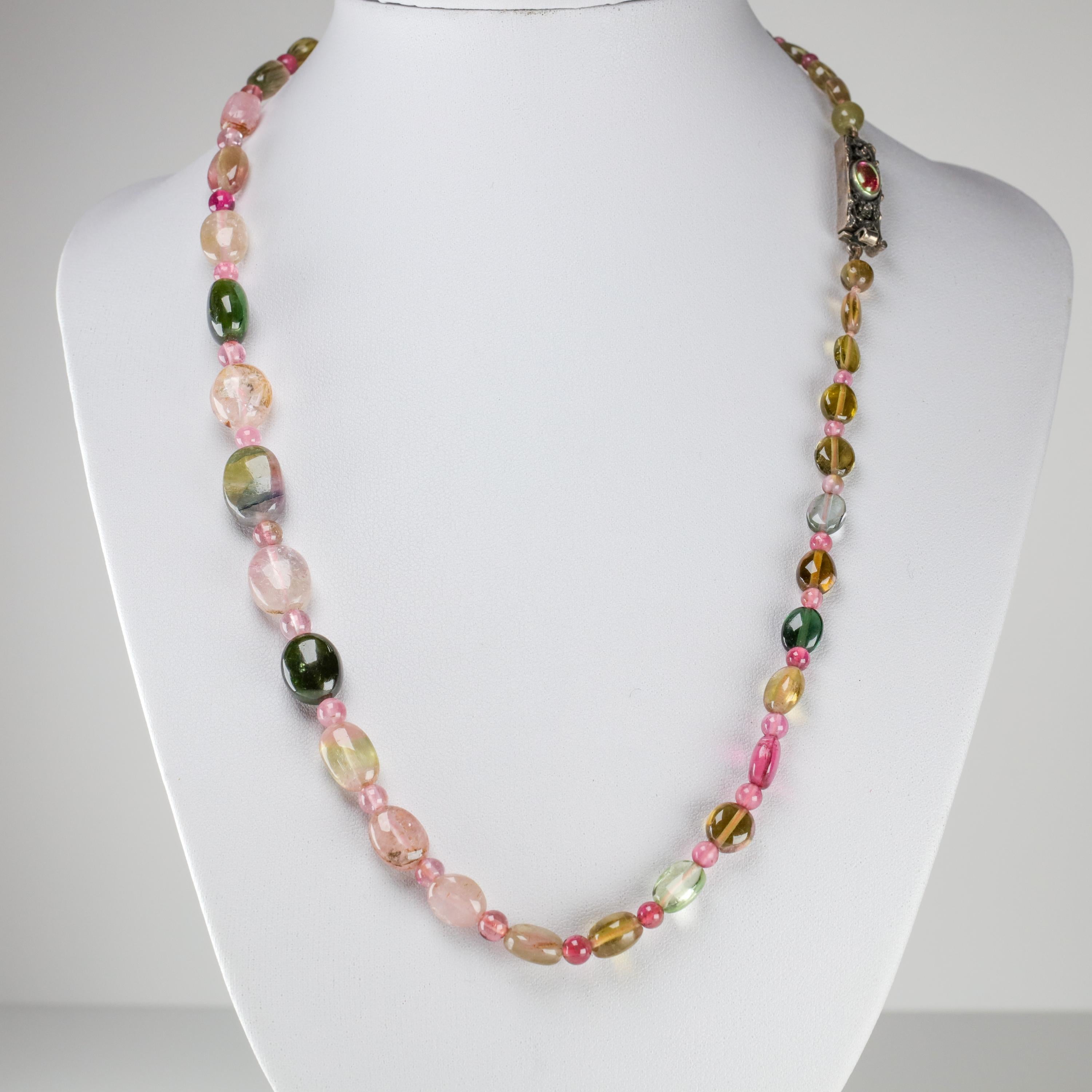 A bright and colorful treasure from the Arts & Crafts period, this English-made necklace is composed of thirty-seven very fine oblong tourmaline beads graduating in size from approximately 8mm to just shy of 14mm. Between these beads are thirty-four