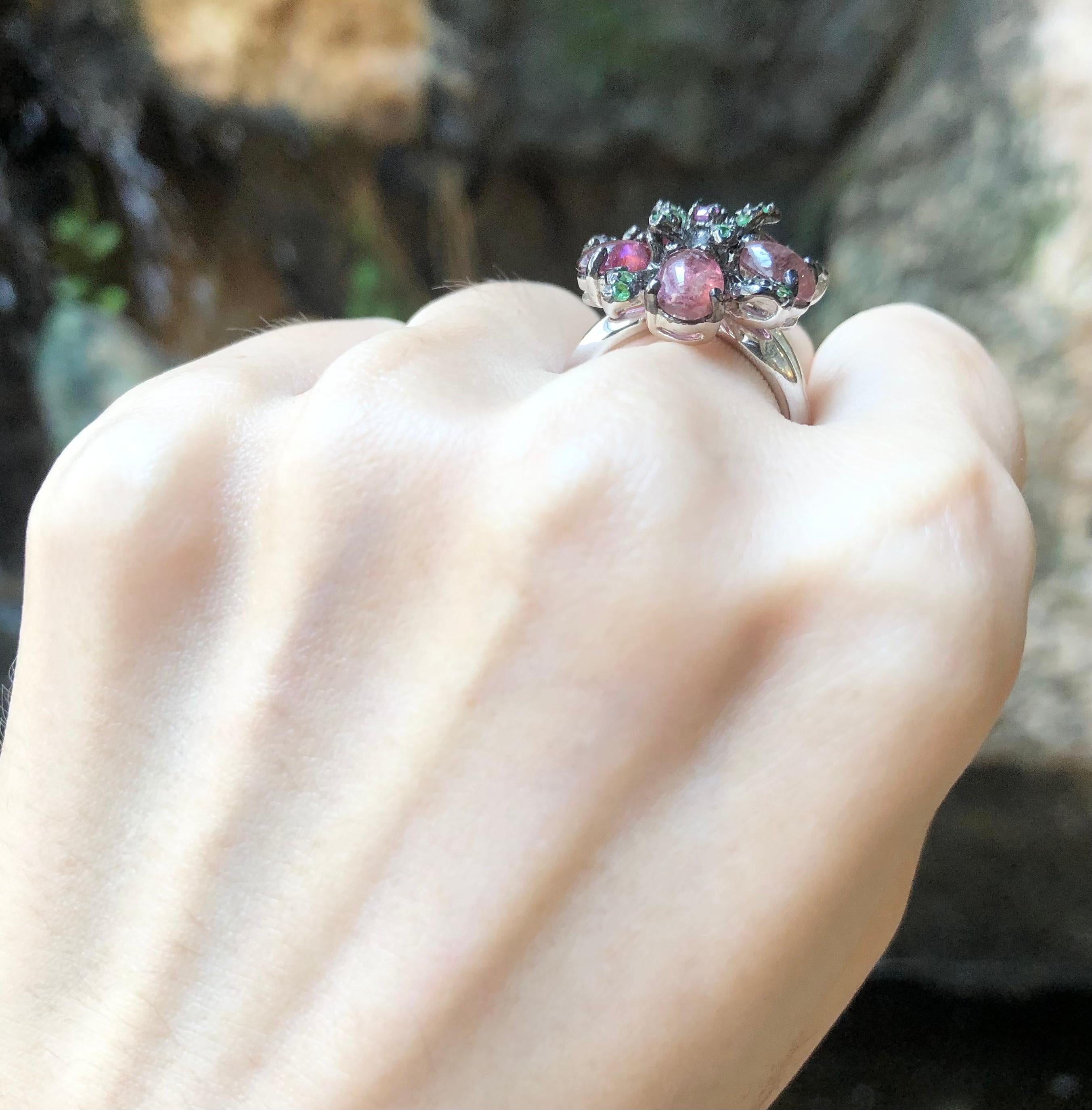 Tourmaline, Pink Sapphire and Tsavorite Ring set in Silver Settings

Width:  2.3 cm 
Length: 2.3 cm
Ring Size: 54
Total Weight: 8.52 grams

*Please note that the silver setting is plated with rhodium to promote shine and help prevent oxidation. 