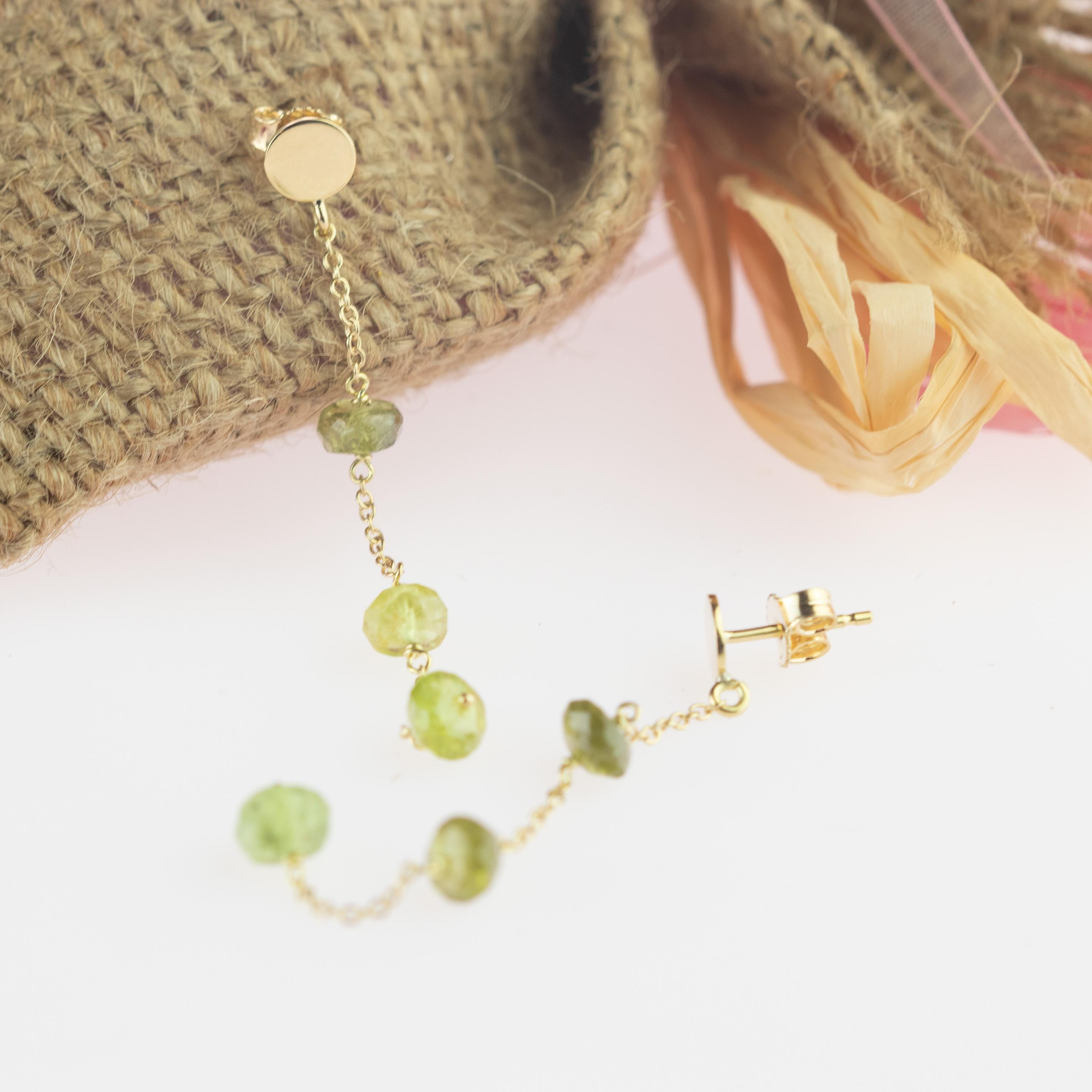 Intini Jewels signature quality on a modern and contemporary design jewel. Stunning long and dangle earrings with three green tourmaline rondelles. Embellished with a 9 karat yellow gold chain will make you look beautiful and full of charm.

Green