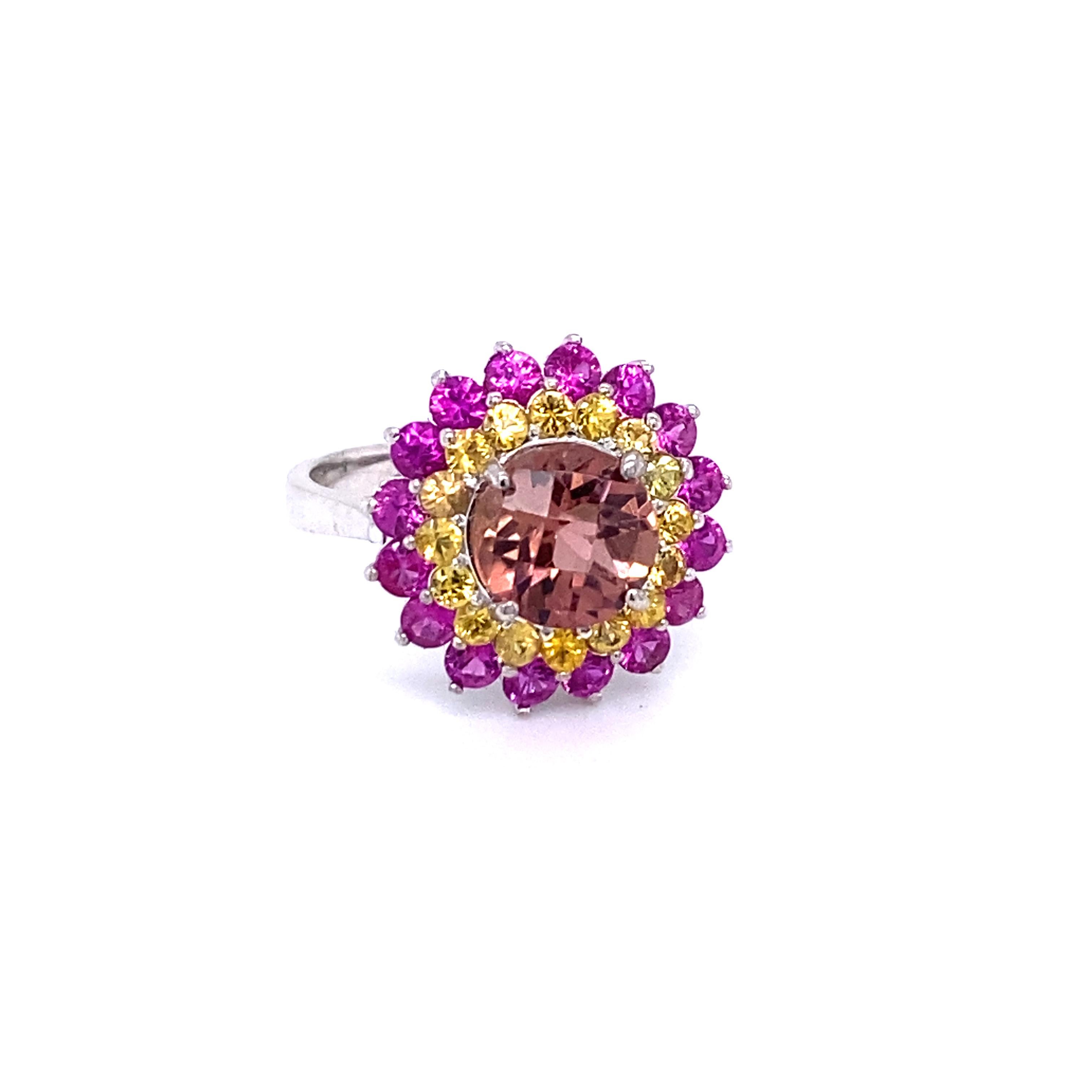 4.29 Carat Tourmaline Sapphire 14 Karat White Gold Cocktail Ring

This ring has a Checkered Round Cut 2.17 Carat Tourmaline that is set in the center of the ring and is surrounded by 32 Yellow and Pink Sapphires that weigh 2.12 Carats.  The total