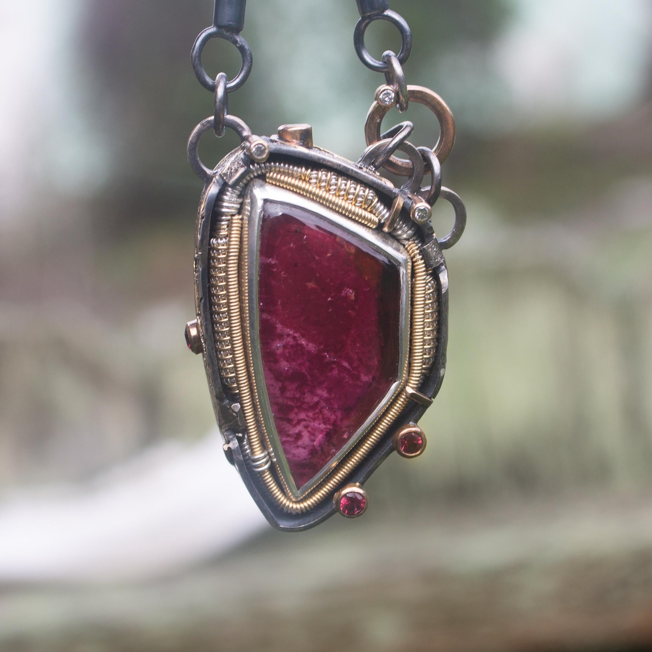 Beautiful deep red Liddicoatite Tourmaline freeform cabochon from Madagascar. Featuring a stunning combination of wire, fabrication, and stone setting that create striking textures and accentuate the beauty of the tourmaline. There are four Spinels